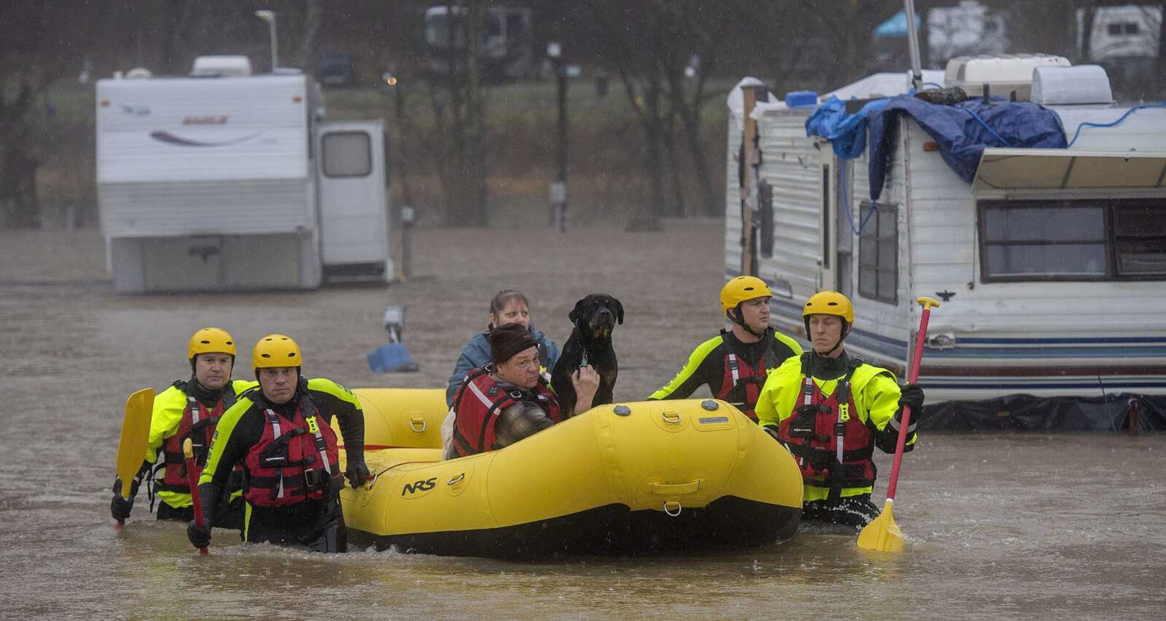 The Bristol, Tennessee, Fire Department's Swift Water Rescue team brings a couple and their three dogs to safety after the Shadrack Campgrounds flooded Thursday in Bristol.