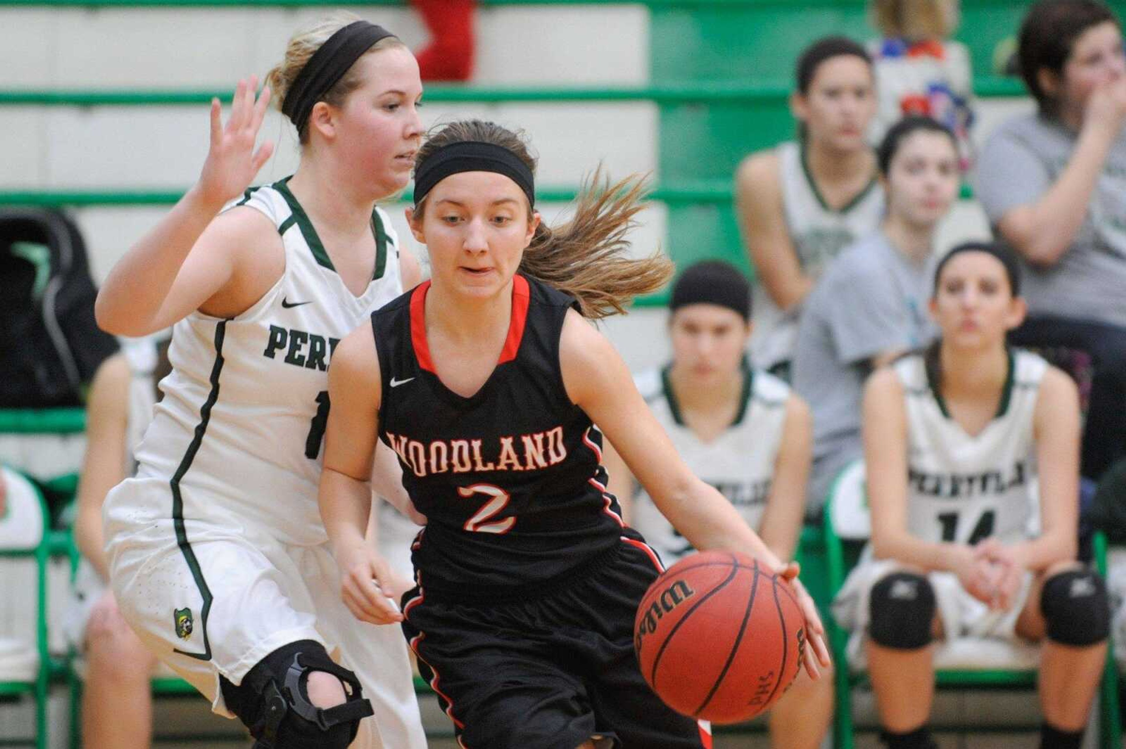 Woodland's Cheyenne Wells drives past a Perryville defender during the second quarter Thursday.