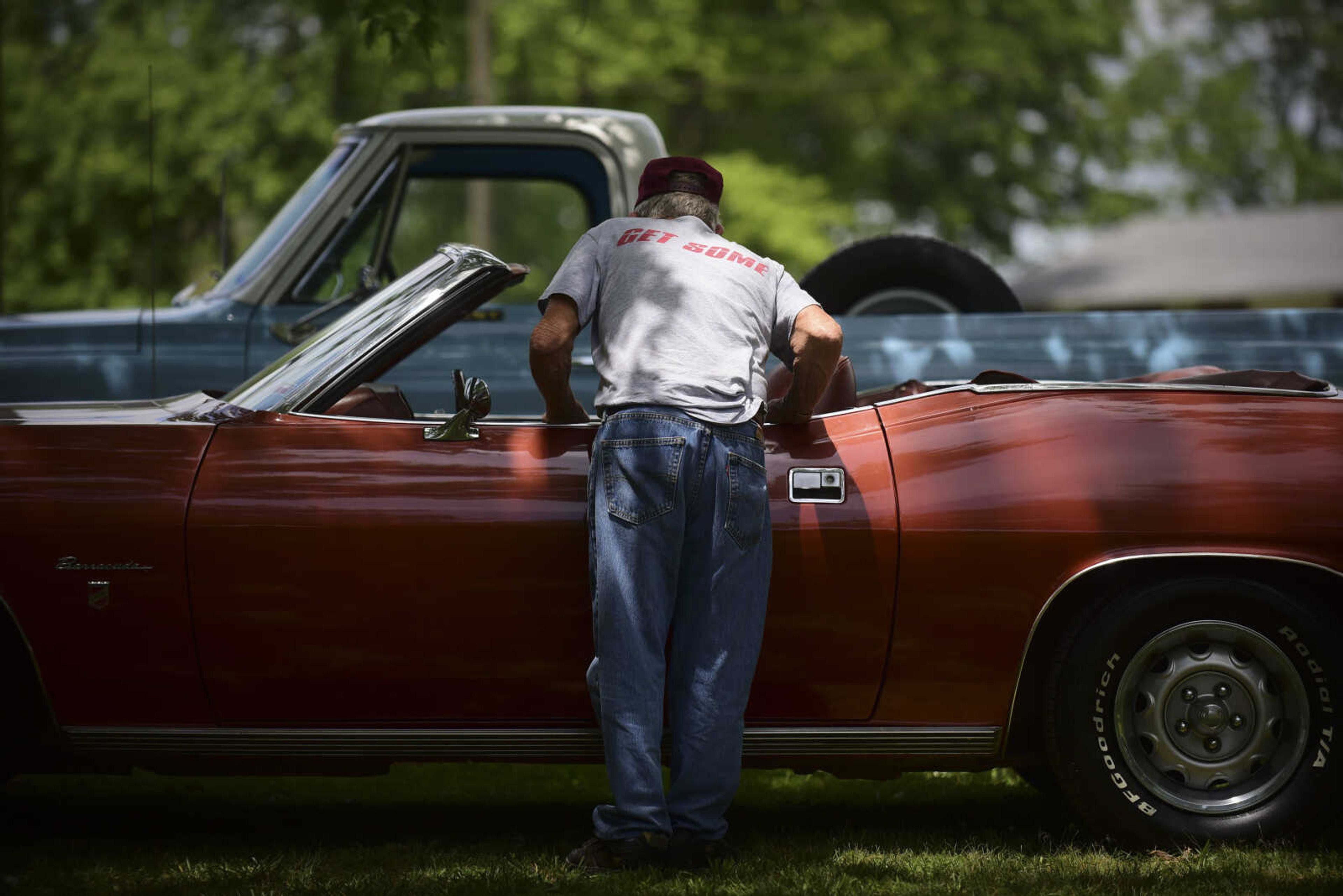 People look at vehicles during the 22nd annual Oran Car Show at George Tilles Jr. Memorial Park Saturday, June 3, 2017 in Oran.