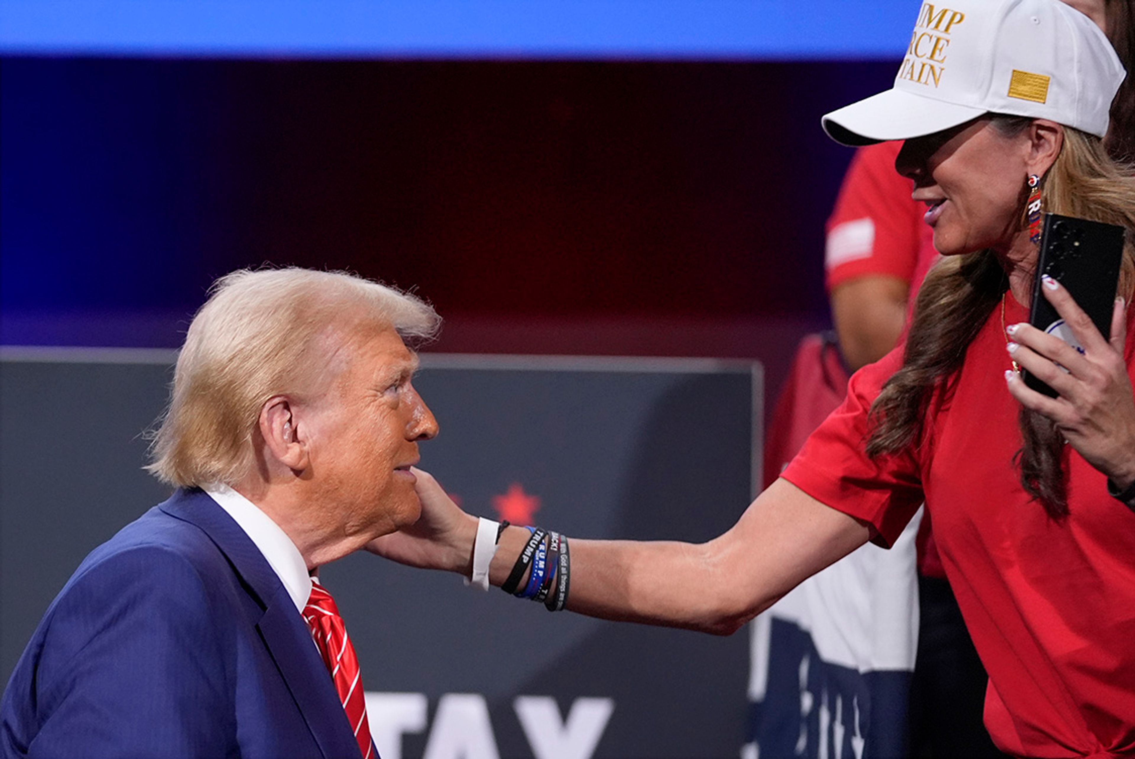 A supporter greets Republican presidential nominee former President Donald Trump after a campaign event at the Cobb Energy Performing Arts Centre, Tuesday, Oct. 15, 2024, in Atlanta. 