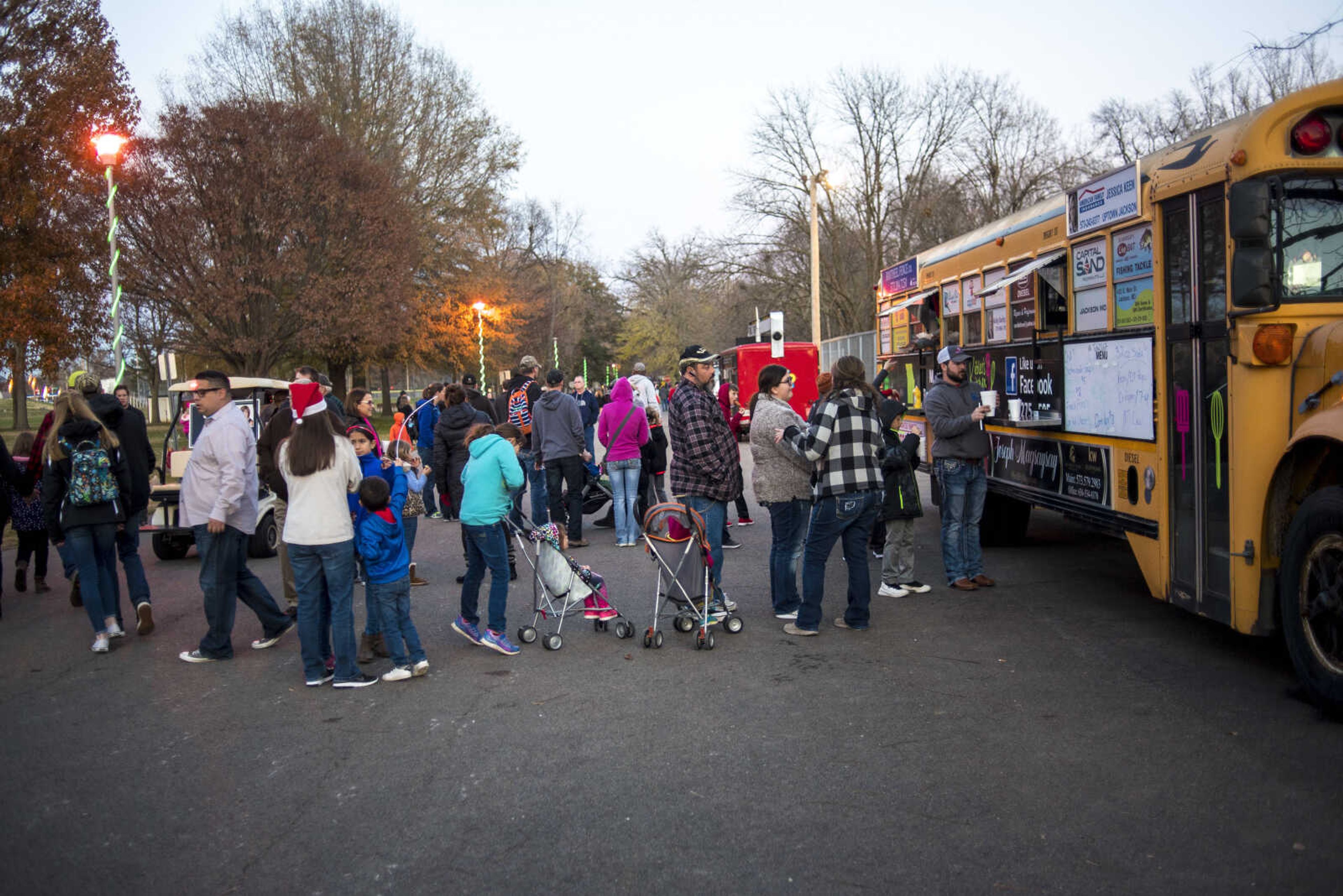 People wait in line for food during the Jackson Holiday Extravaganza Friday, Nov. 24, 2017 at the Jackson City Park.