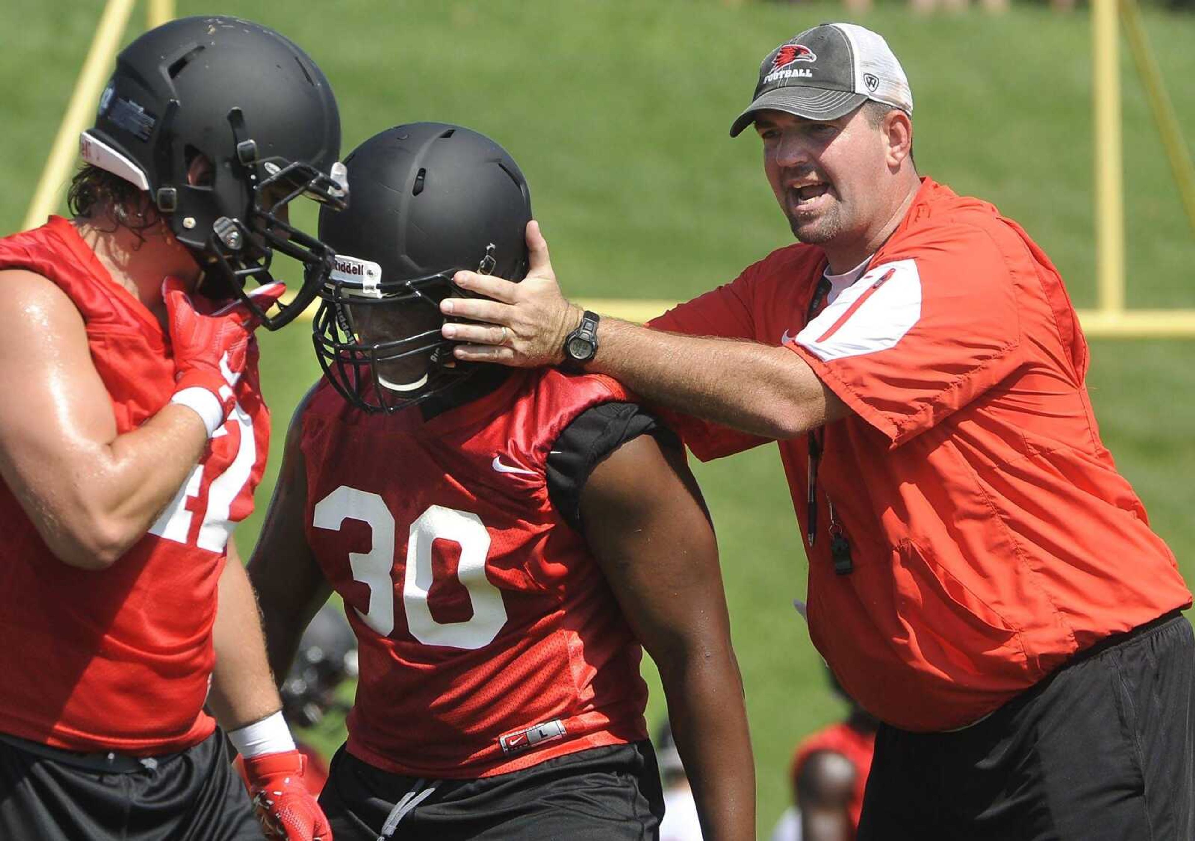 Southeast Missouri State coach Tom Matukewicz works with his players during a drill Thursday during the team's first official practice at Rosengarten Athletic Complex.