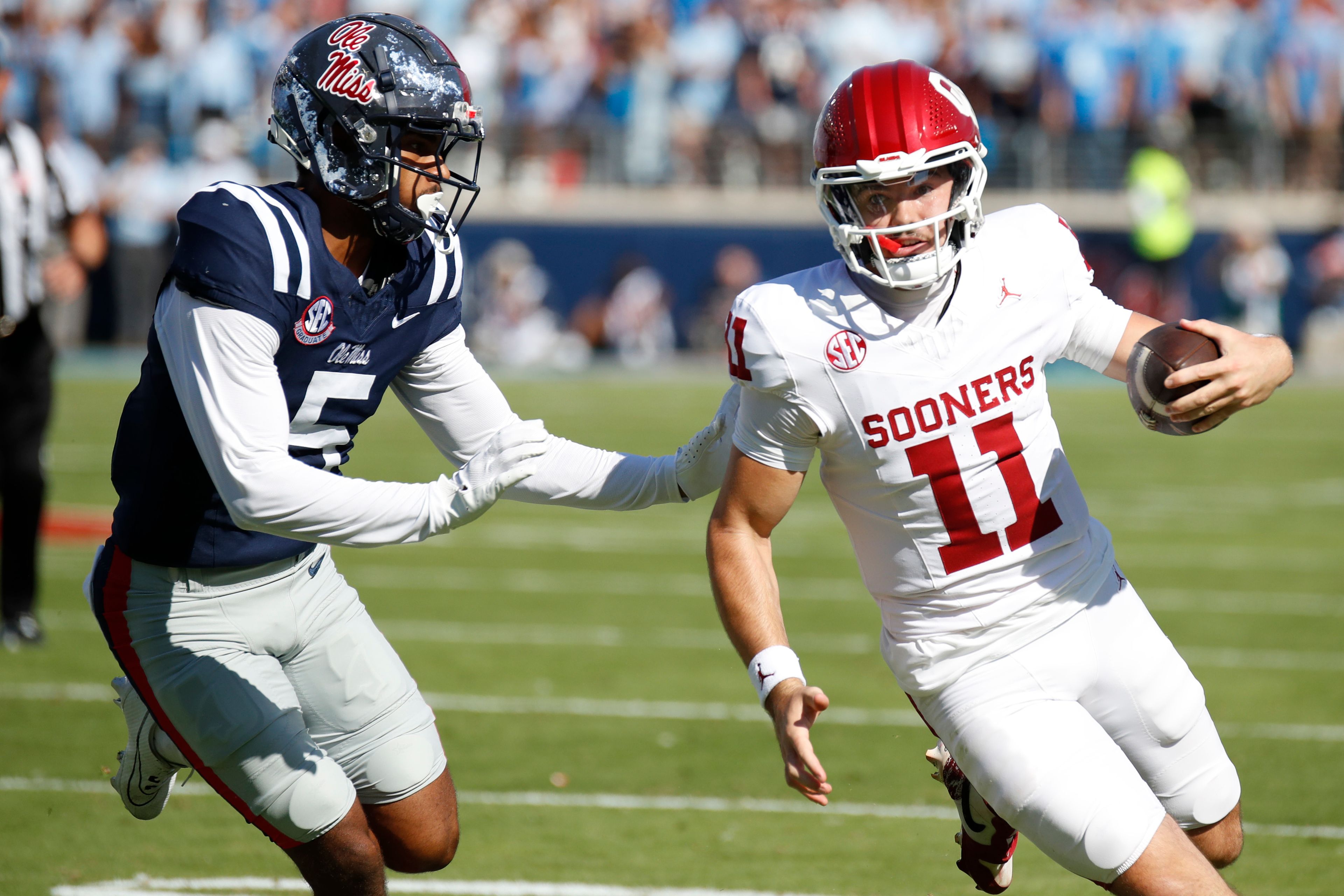 Oklahoma quarterback Jackson Arnold (11) tries to get around Mississippi strong safety John Saunders Jr. (5) during the first half of an NCAA college football game Saturday, Oct. 26, 2024, in Oxford, Miss. (AP Photo/Sarah Warnock)