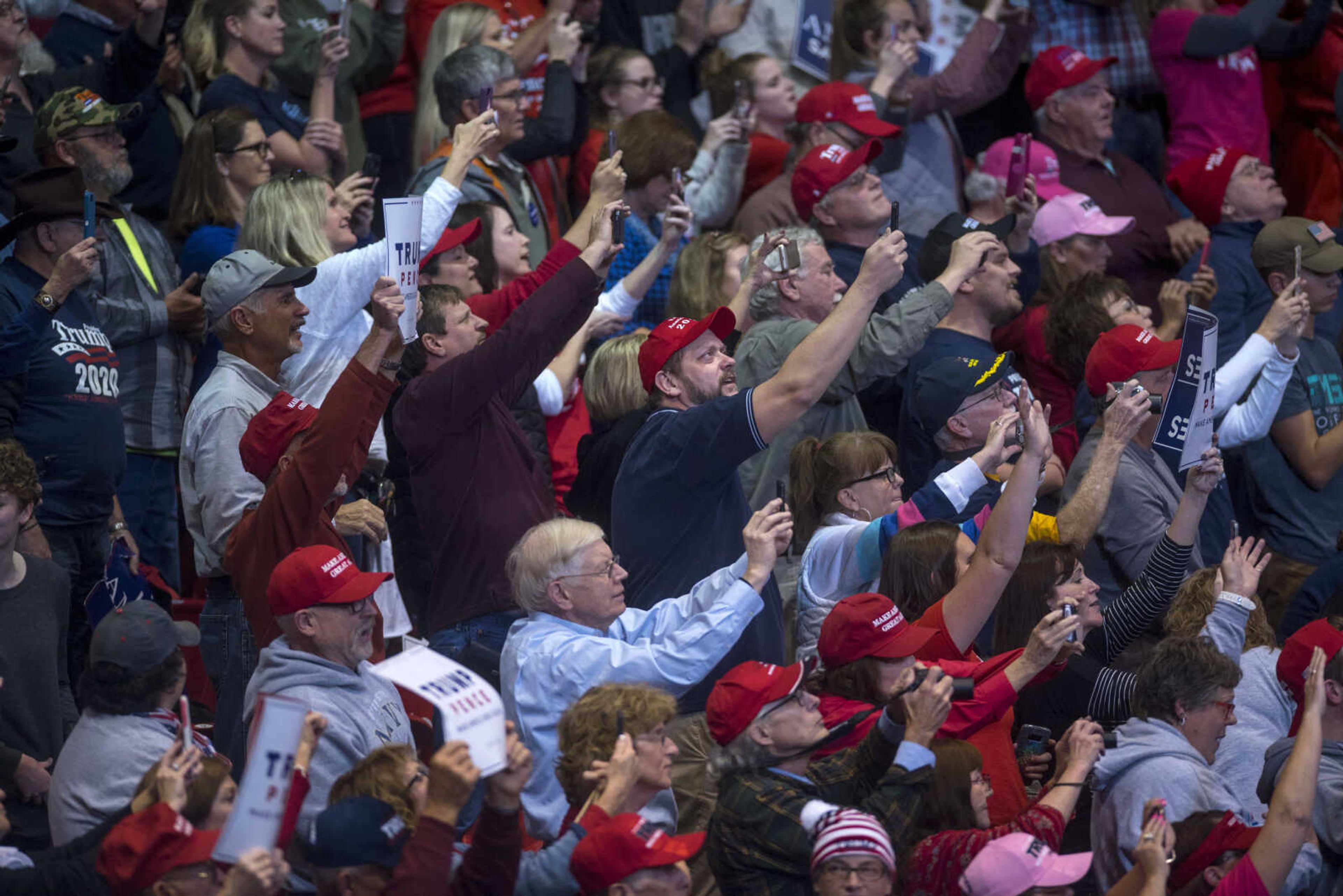 The crowd films the President as he takes the stage at the Show Me Center during a rally Monday.