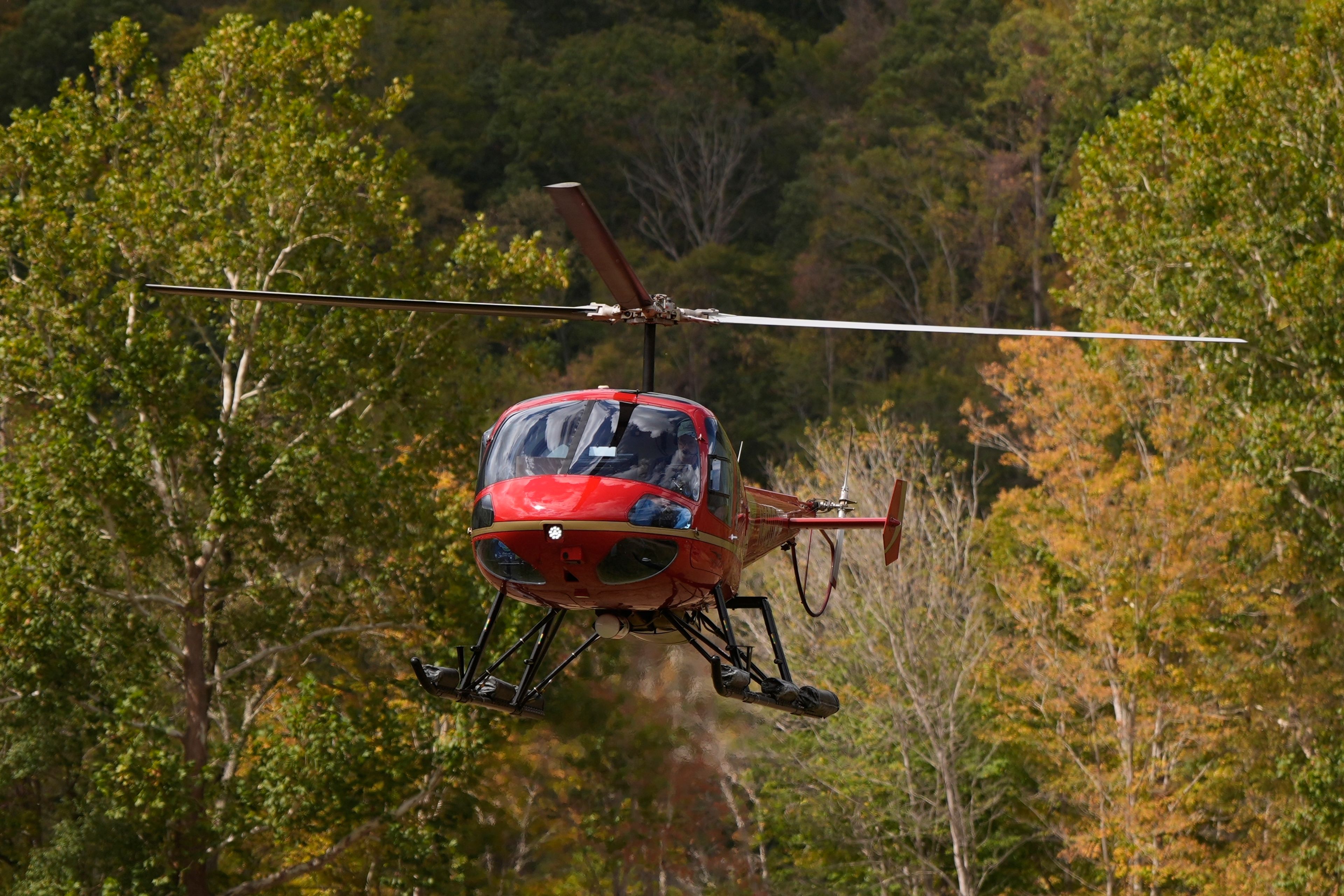 A helicopter lands at the volunteer fire station in the aftermath of Hurricane Helene, Thursday, Oct. 3, 2024, in Pensacola, N.C. (AP Photo/Mike Stewart)