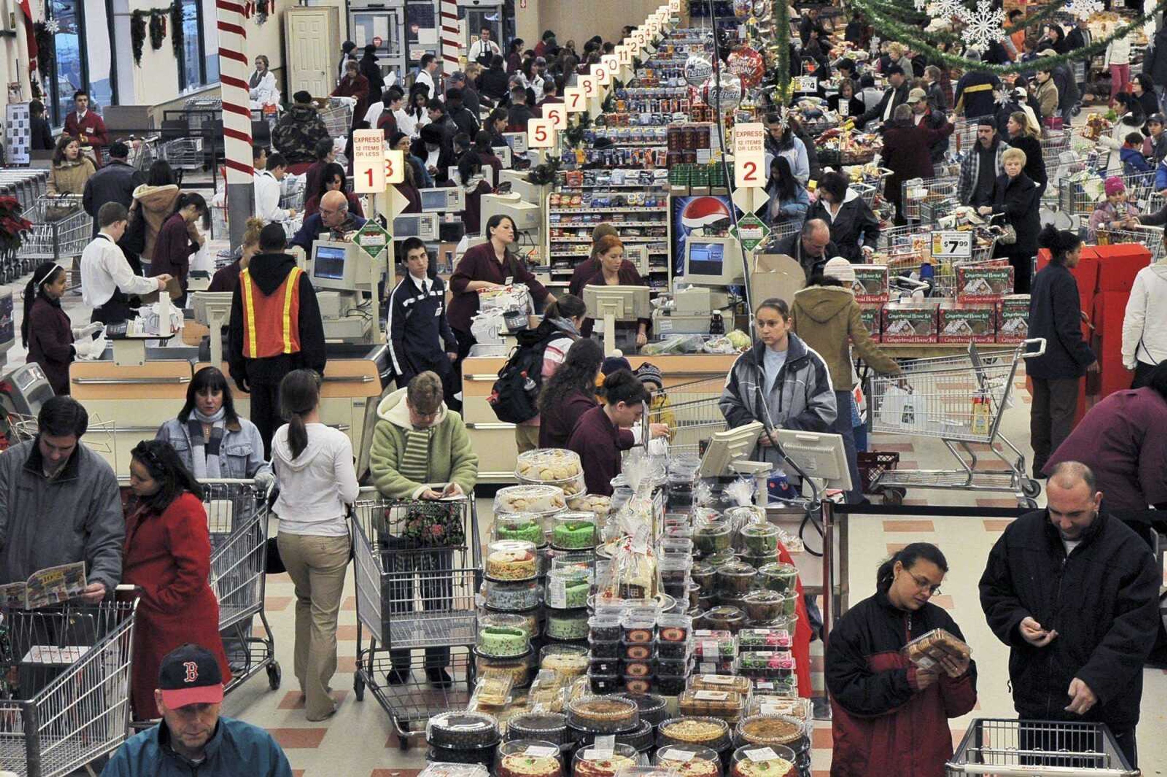 Shoppers stocked up at a grocery store Saturday in Danvers, Mass., before the next winter storm hits. (Lisa Poole ~ Associated Press)