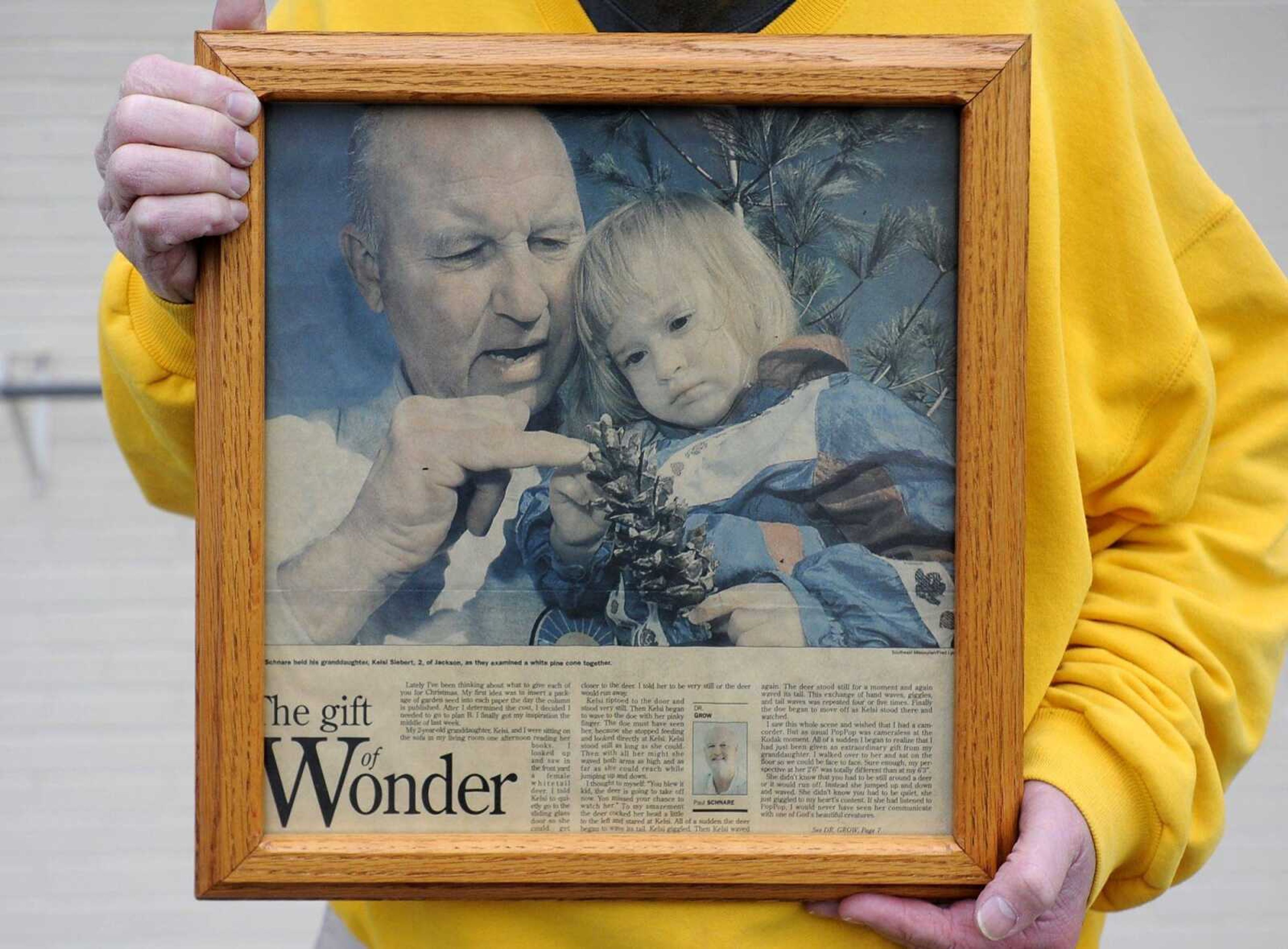 Paul Schnare holds a framed copy of his gardening column that features his granddaughter, Kelsi Siebert, when she was 2 years old as published Dec. 16, 1998 in the Southeast Missourian.