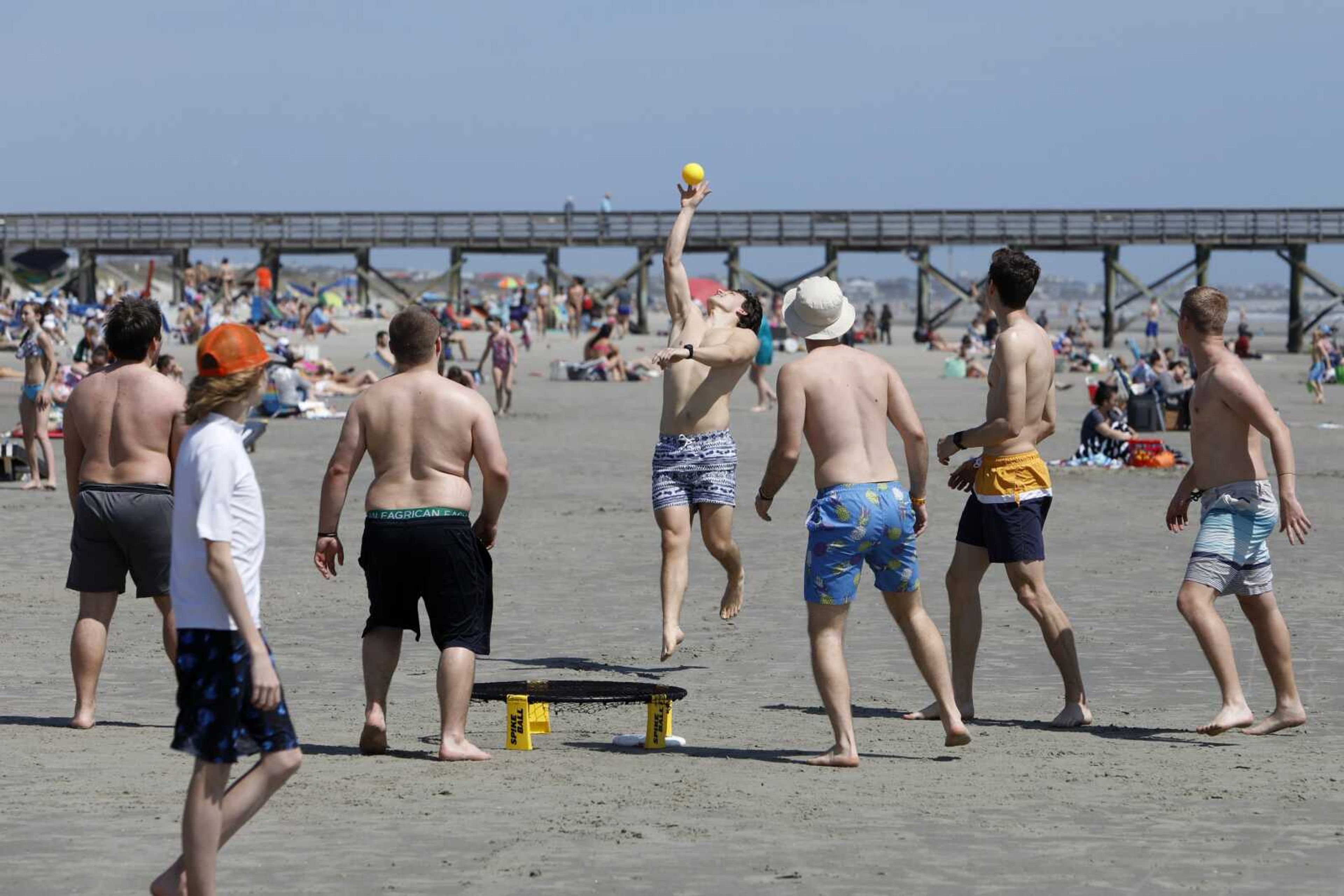 Despite warnings from government officials to take caution and self distance because of coronavirus, beach goers enjoy the Isle of Palms beach Friday in Isle of Palms, South Carolina. City authorities are restricting access to the popular beach from 7 a.m. to 7 p.m. daily as of Saturday to help stop the spread of the coronavirus.