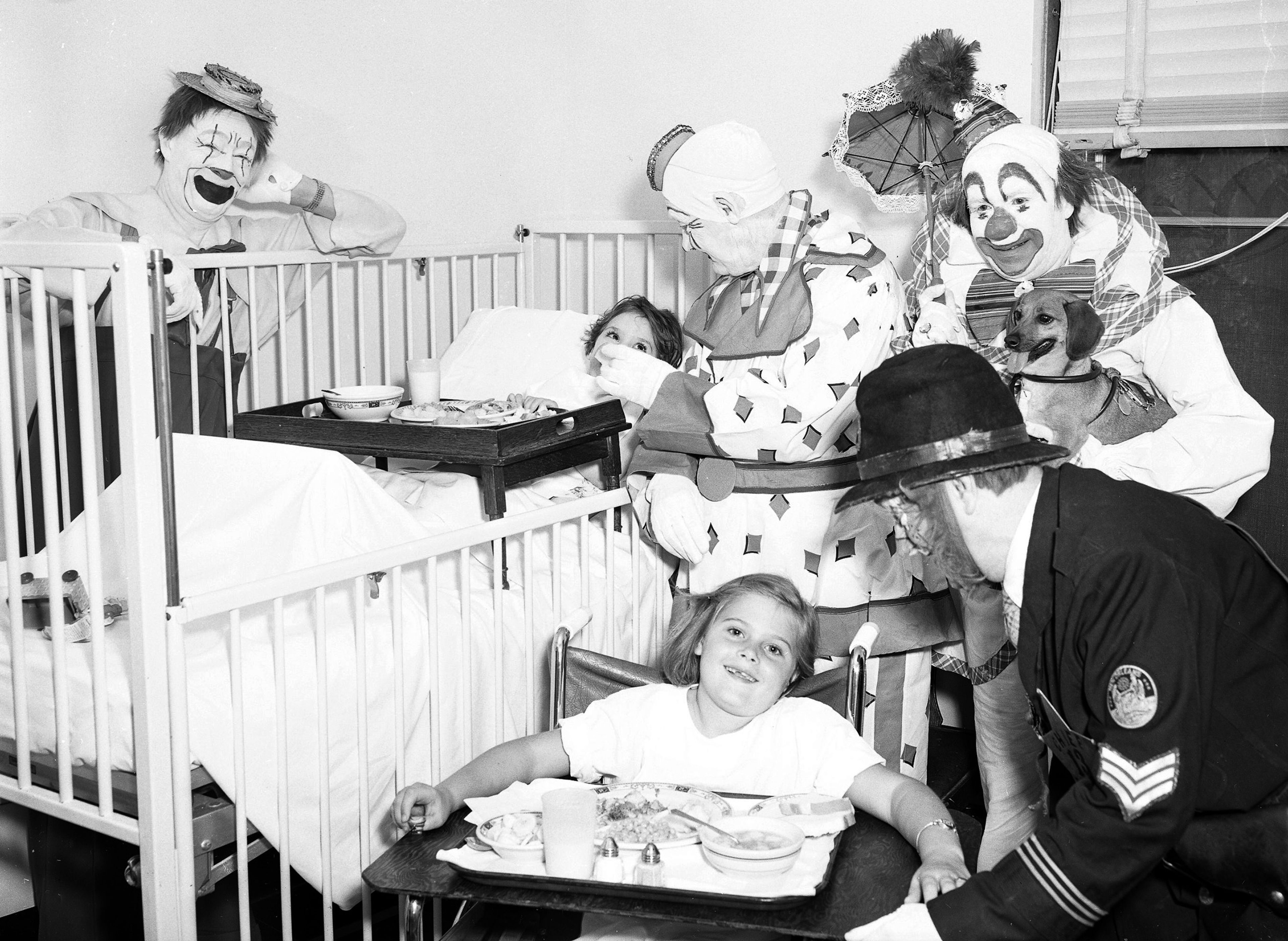 Circus folks, performing in Cape Girardeau as part of the Southeast Missourian's 50th anniversary celebration, visit with polio patients at Saint Francis Hospital on June 7, 1954. The children are Ruthie De Hart, 5, of Malden in the bed and Sondra C. Dickerson, 6, of Mound City, Illinois, in the wheelchair. 
