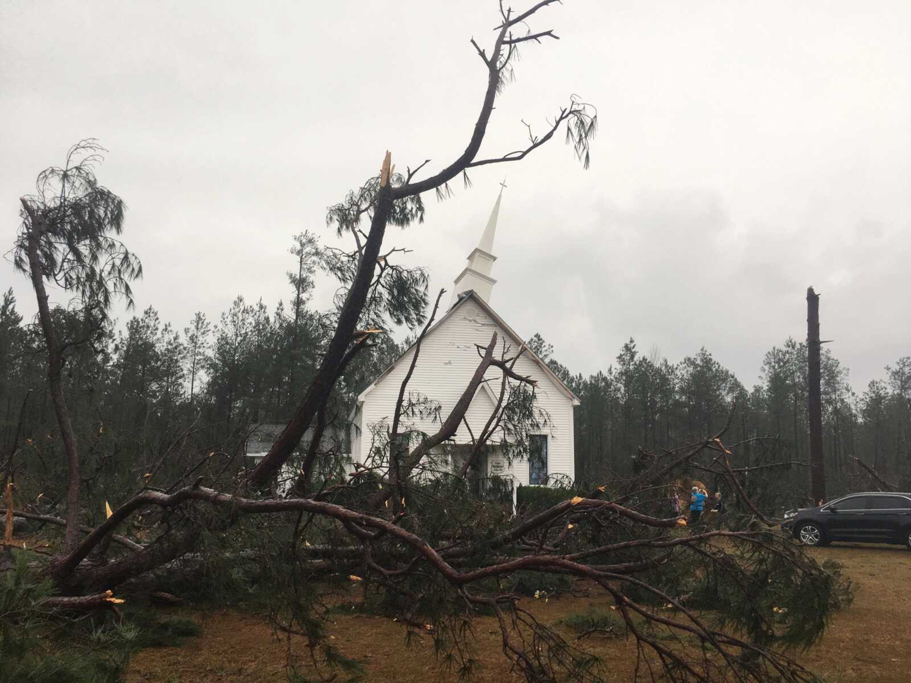 Fallen trees sit near Zoar United Methodist Church which sustained damage to its steeple Sunday near Baxley, Georgia.