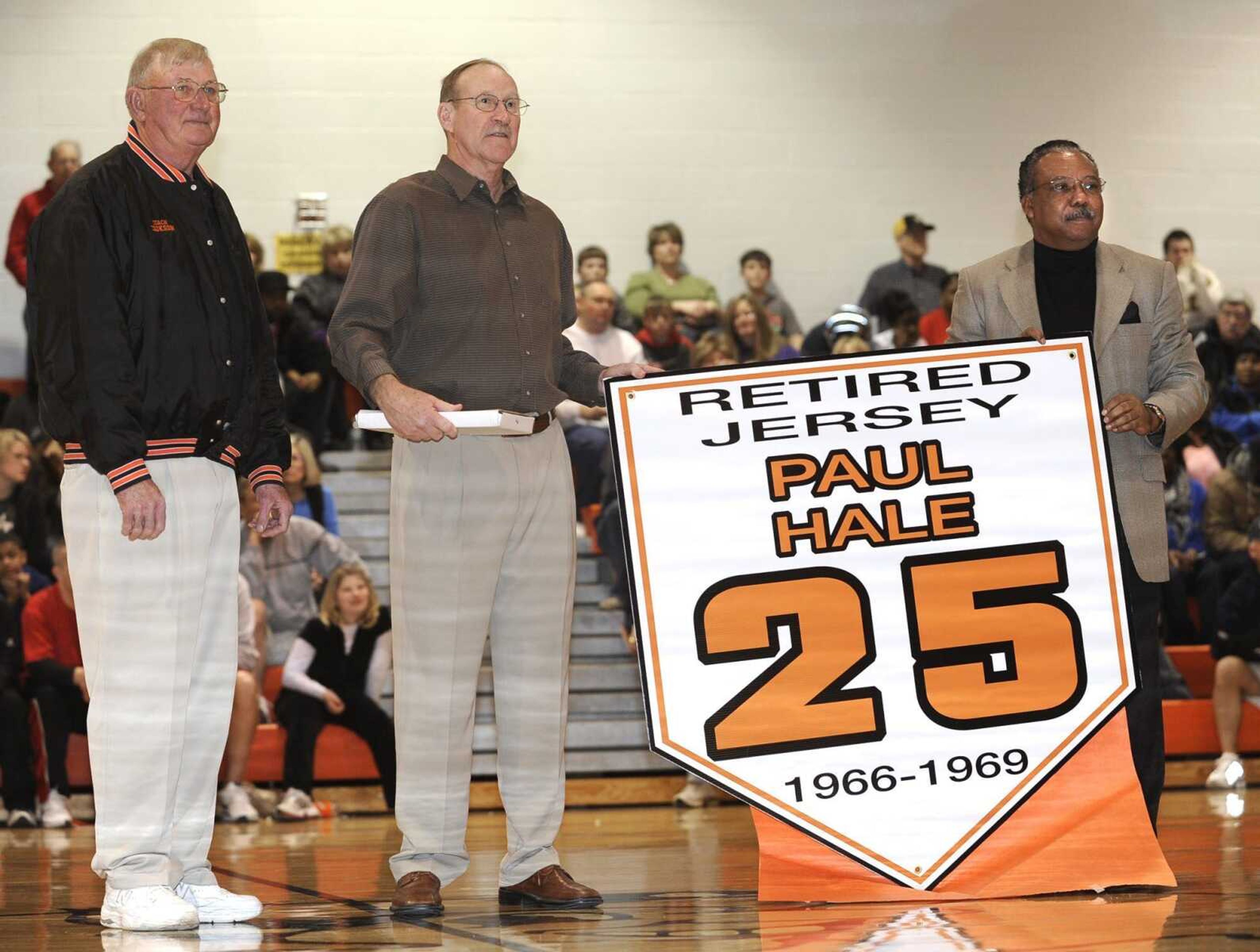 Paul Hale, center, stands with Scott County Central superintendent Al McFerren, right, and coach Ronnie Cookson during a ceremony to retire Hale's No. 25 jersey Saturday at Scott County Central High School. Check out more photos from the game in our gallery at semoball.com. (Fred Lynch)