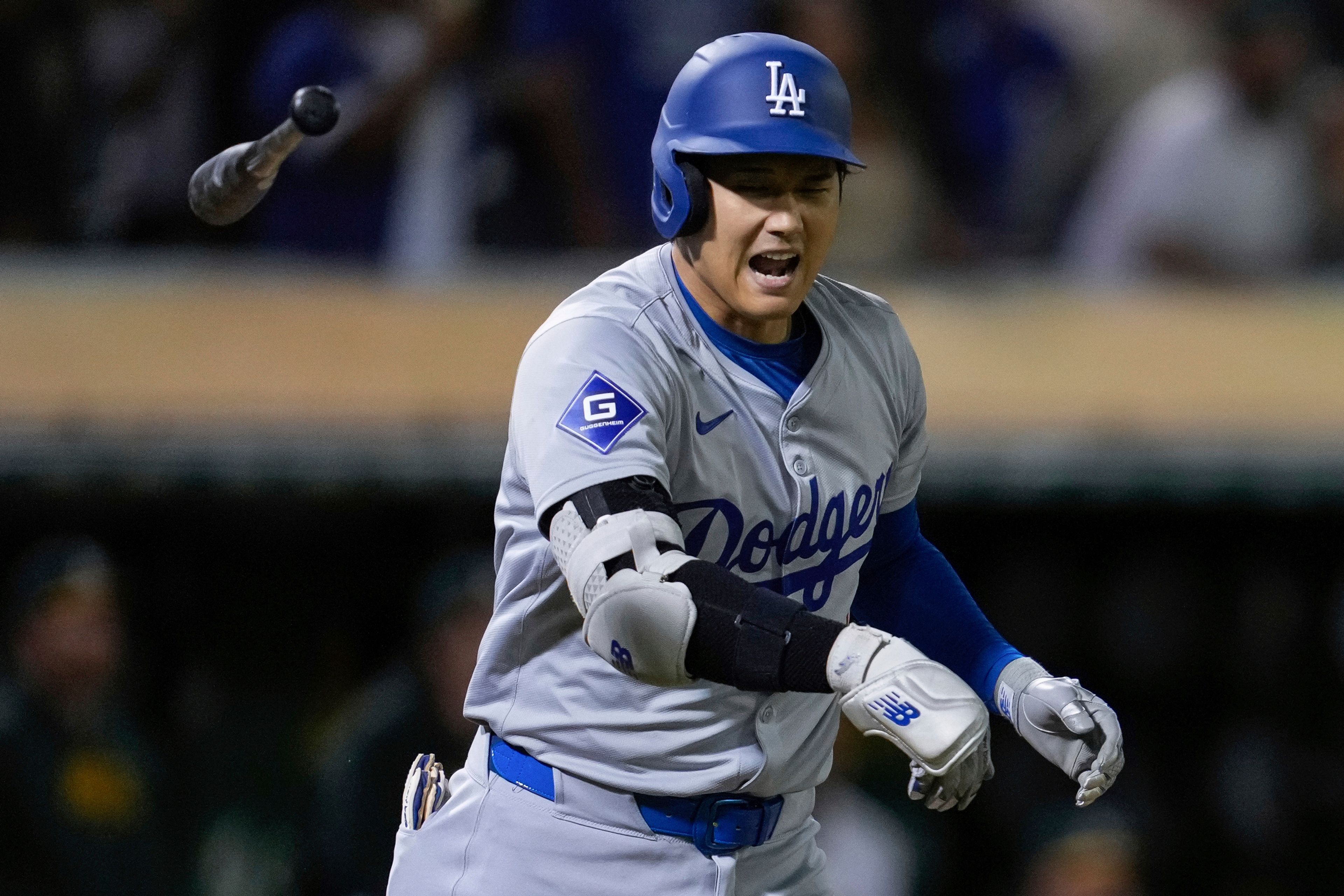 Los Angeles Dodgers' Shohei Ohtani tosses his bat after hitting a three-run home run against the Oakland Athletics during the ninth inning of a baseball game Friday, Aug. 2, 2024, in Oakland, Calif. (AP Photo/Godofredo A. Vásquez)