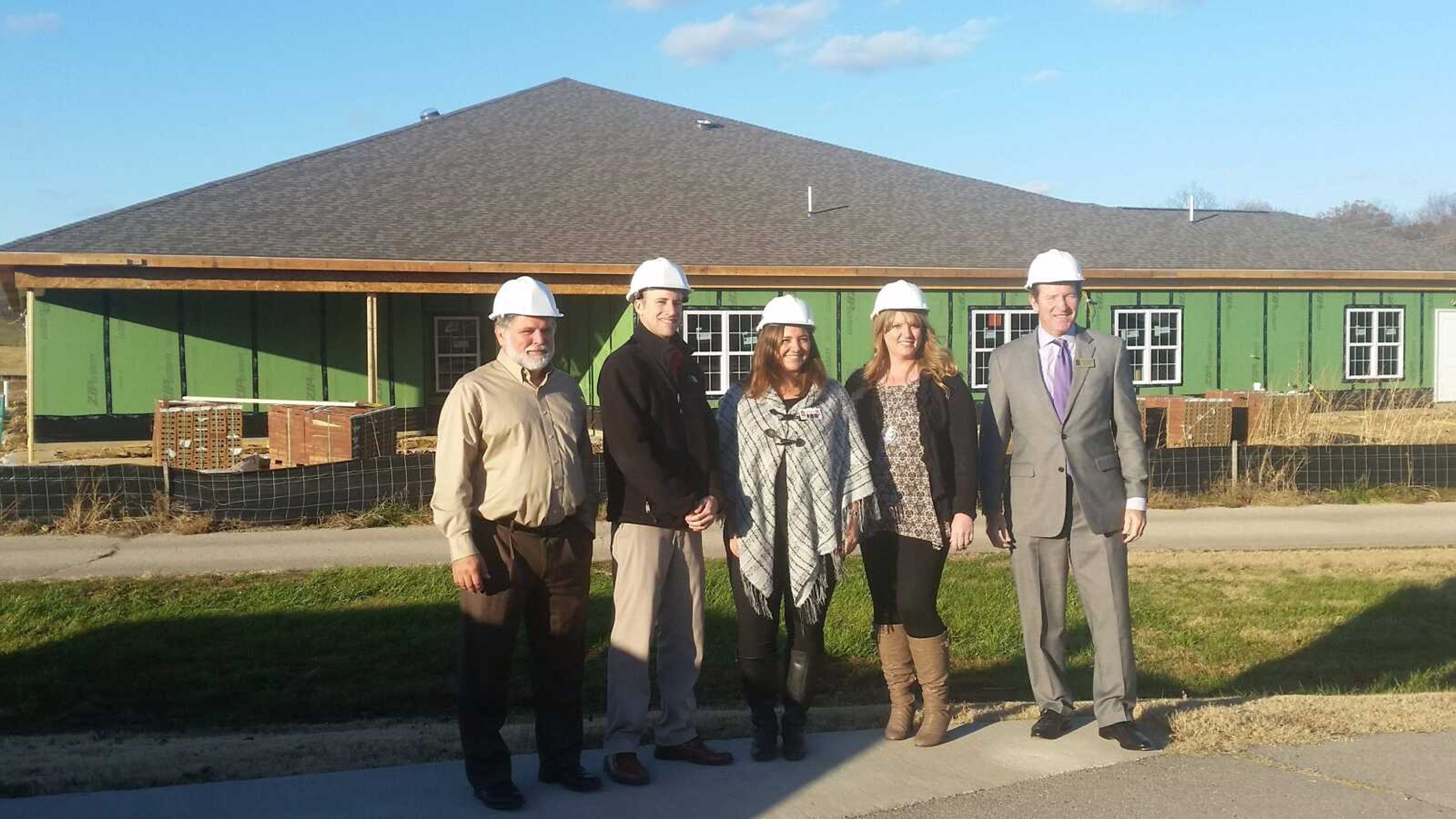 From left,  Mike Landawee, Jeff Branch, Morgan Beasley, Mary Eaves and Clay Crosson, president of Americare, stand in front of The Arbors of Capetown development.