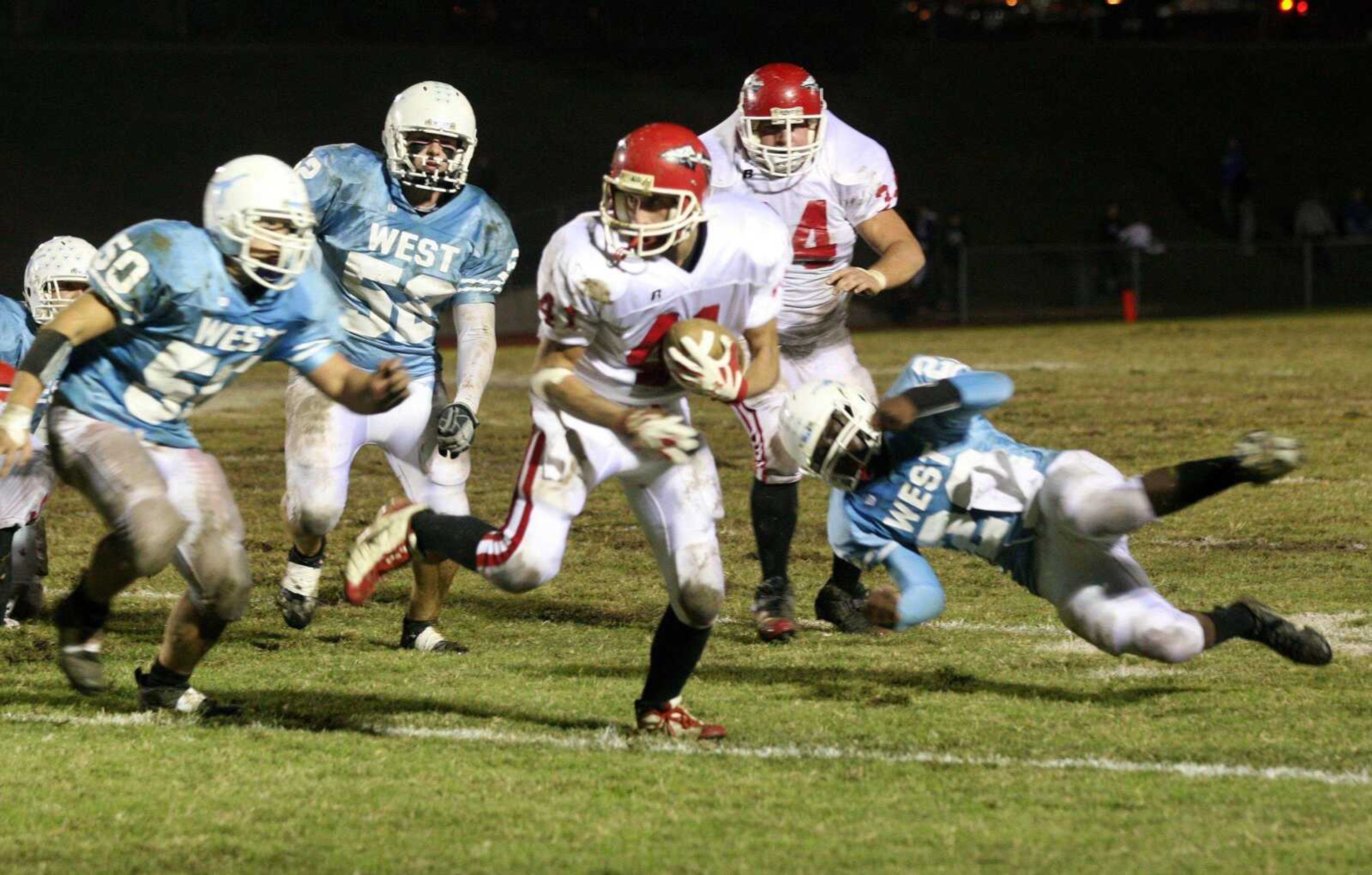 Jackson's Adam Zweigart (41) evaded Parkway West defenders Nick Urban (5), Colton Long (52) and Torrence Watkins during Friday's game in Ballwin, Mo. (Paul Kopsky ~ Special to the Southeast Missourian)