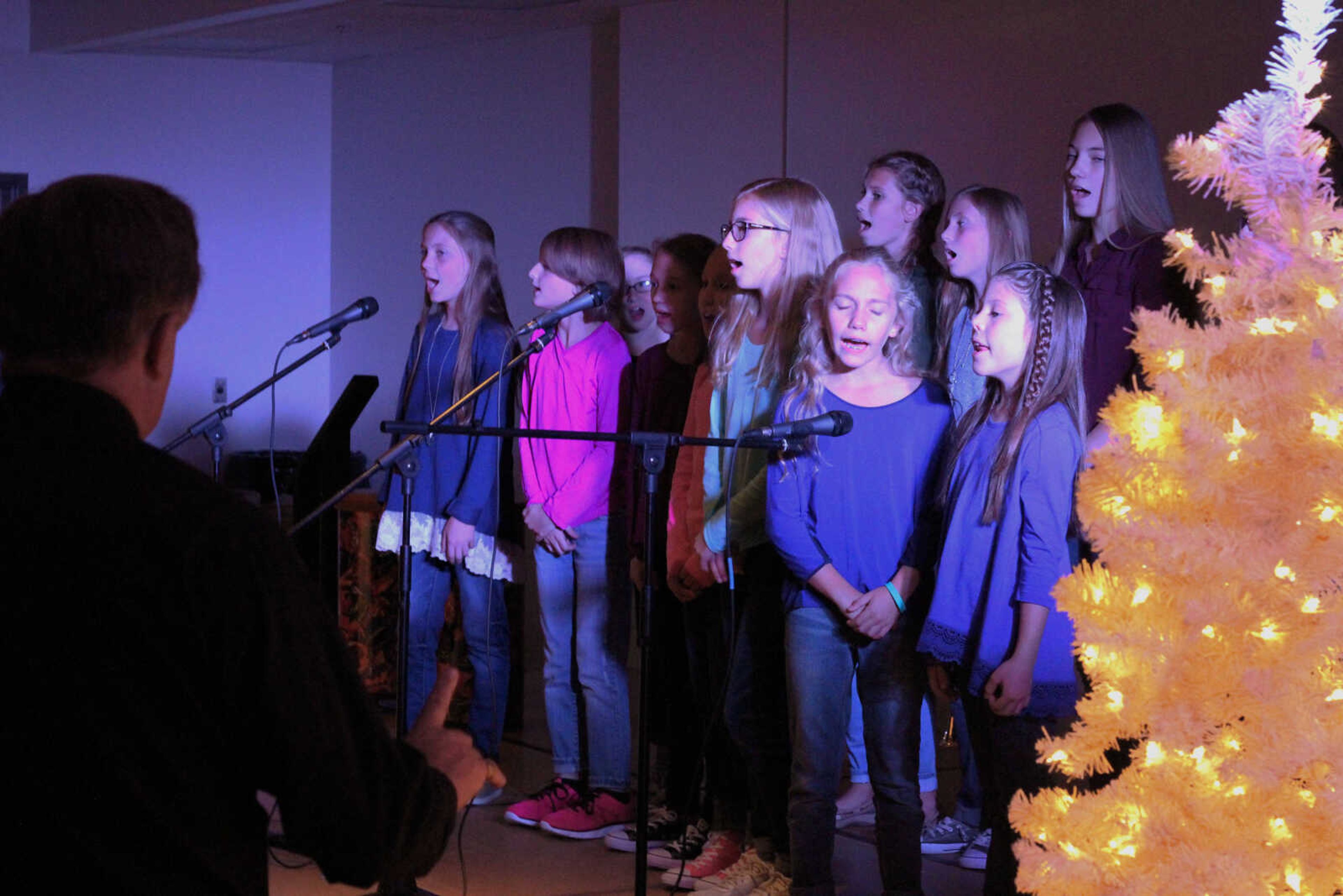 Immaculate Conception music director Jerry Ganiel leads the Immaculate Conception Church Choristers during their performance of "The Circle of Life" from The Lion King.