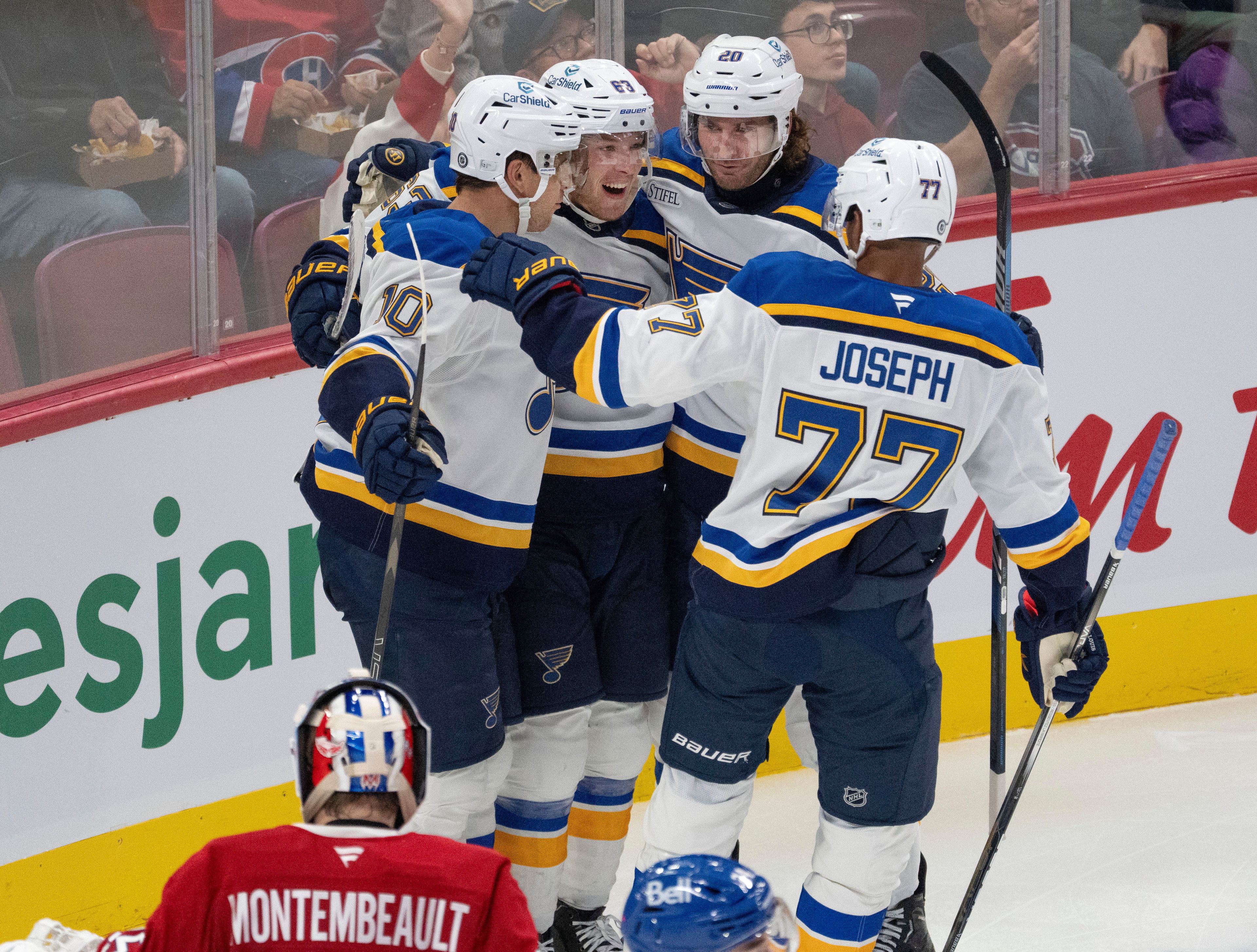 St. Louis Blues' Jake Neighbours (63) celebrates with teammates after scoring on Montreal Canadiens goaltender Sam Montembeault during the second period of an NHL hockey game Saturday, Oct. 26, 2024 in Montreal. (Ryan Remiorz/The Canadian Press via AP)