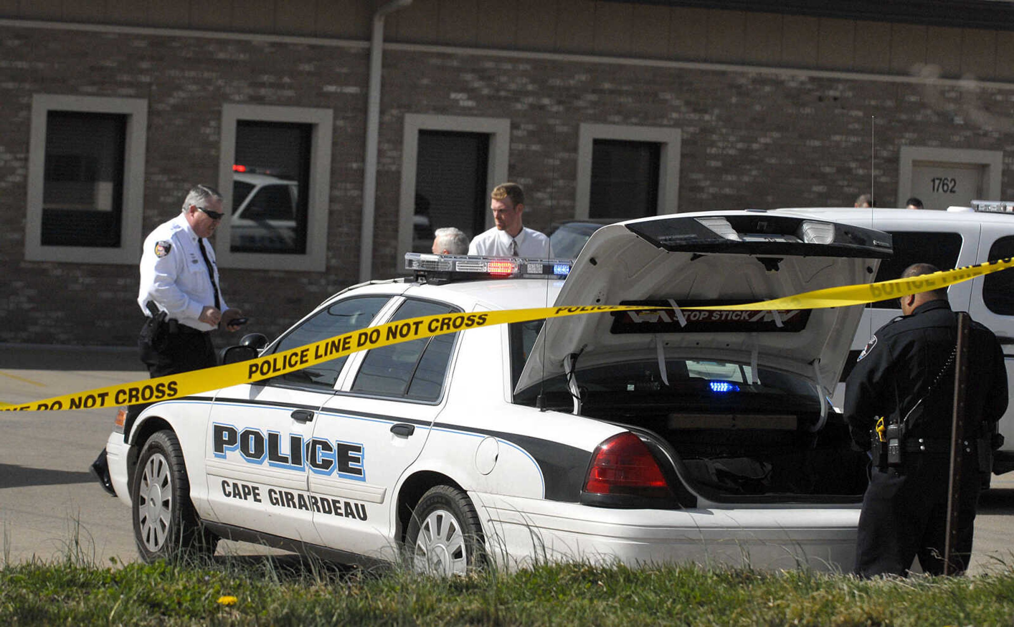 LAURA SIMON ~ lsimon@semissourian.com
Cape Girardeau emergency responders work the scene of a victim of a self-inflicted gun shot wound outside Dan's Key and Lock Tuesday afternoon, March 6, 2012. Police say the man is a suspect in a Sunday assault along Cape LaCroix Recreational Trail.