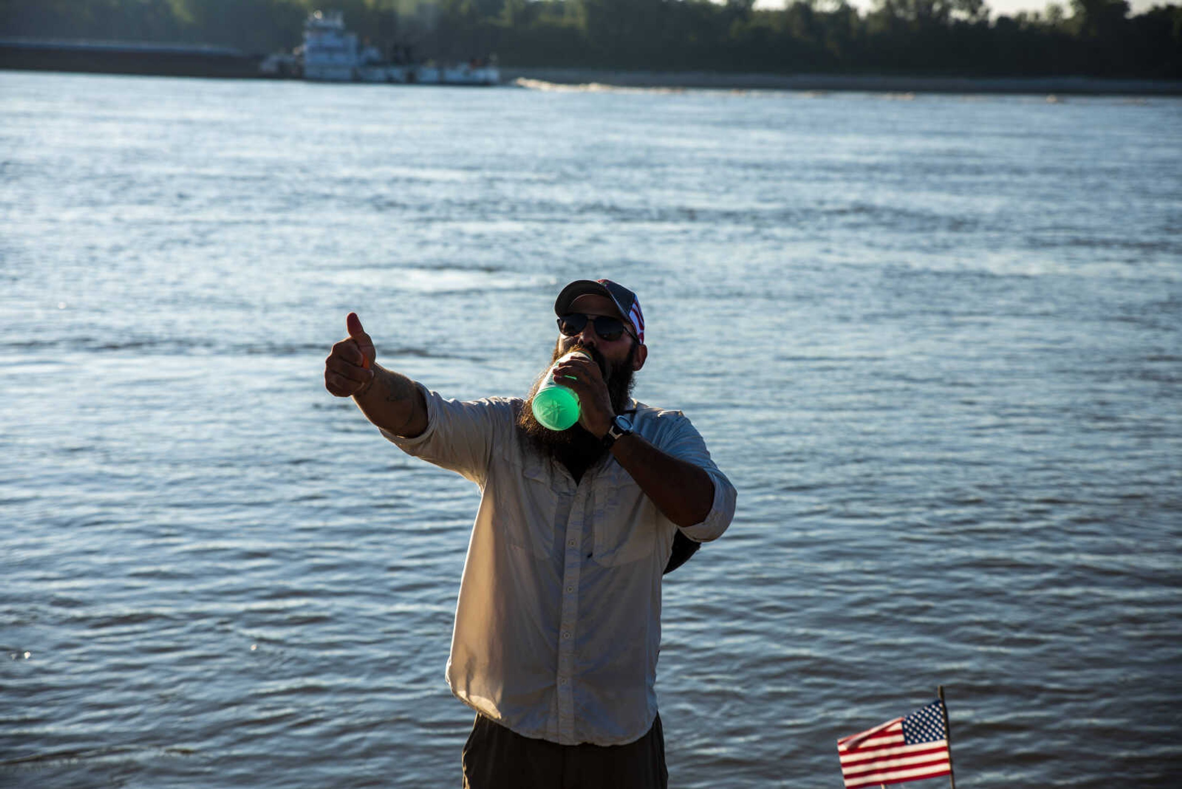 Ryan Webb gives a thumbs up while drinking water as he finishes preparing his kayak at the loading dock at Red Star Dock before hitting the water again during an excursion down the Mississippi River Tuesday, Aug. 28, 2018 in Cape Girardeau. Webb, along with Rick Baine and Matt Roy (not pictured), are making their way down the Mississippi River as part of the Warrior Paddle Expedition, starting at the source of the Mississippi River, Lake Itsaca, Minnesota, and ending in the Gulf of Mexico.