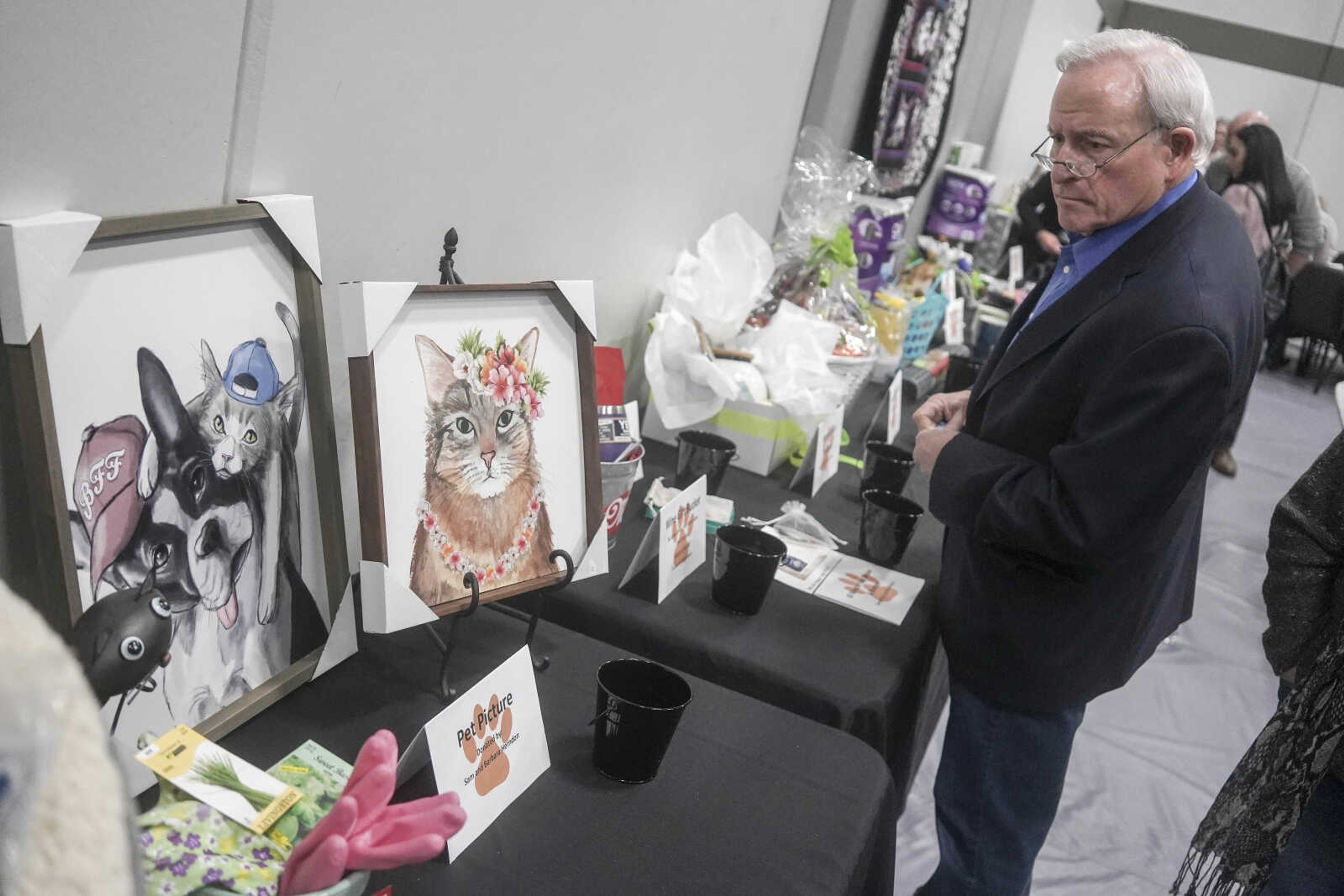 Mark Kasten browses a silent auction during the Humane Society of Southeast Missouri Power of Pawsitivity fundraiser Saturday, Feb. 29, 2020, at the Jackson Civic Center in Jackson.