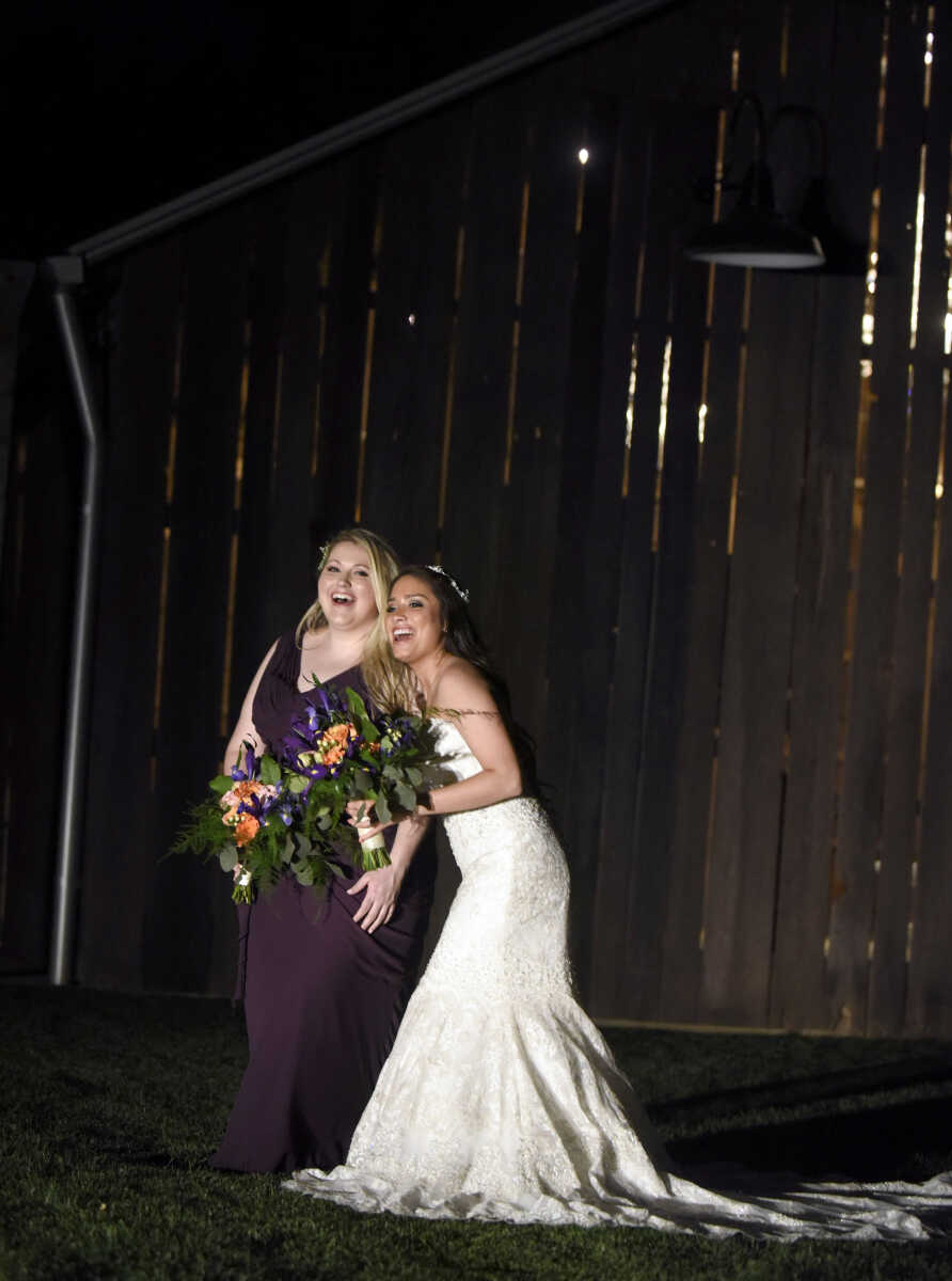 Allure Bridals gown with a detailed head piece from Marionat and rounded square earrings from Jim Ball. Available at Joy's Bridal in Sikeston, Missouri.

Bill Levkoff plum bridesmaid gown with dangly pearl earring from Jim Ball. Available at Joy's Bridal in Sikeston, Missouri.