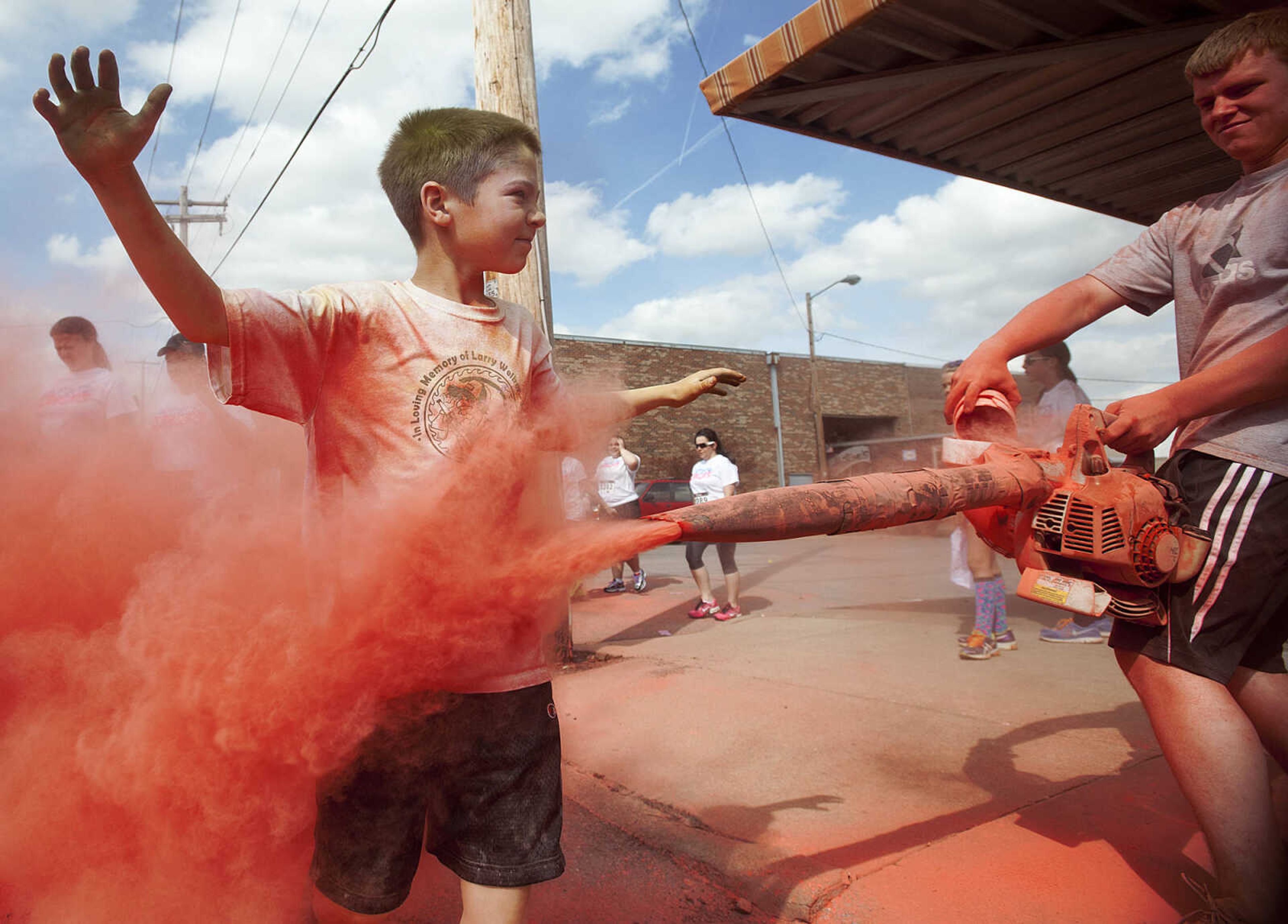 ADAM VOGLER ~ avogler@semissourian.com
Participants in the Color Me Cape 5k are doused with red as they run past the Southeast Missouri State University Cheerleaders near the start Saturday, April 12, in Cape Girardeau.