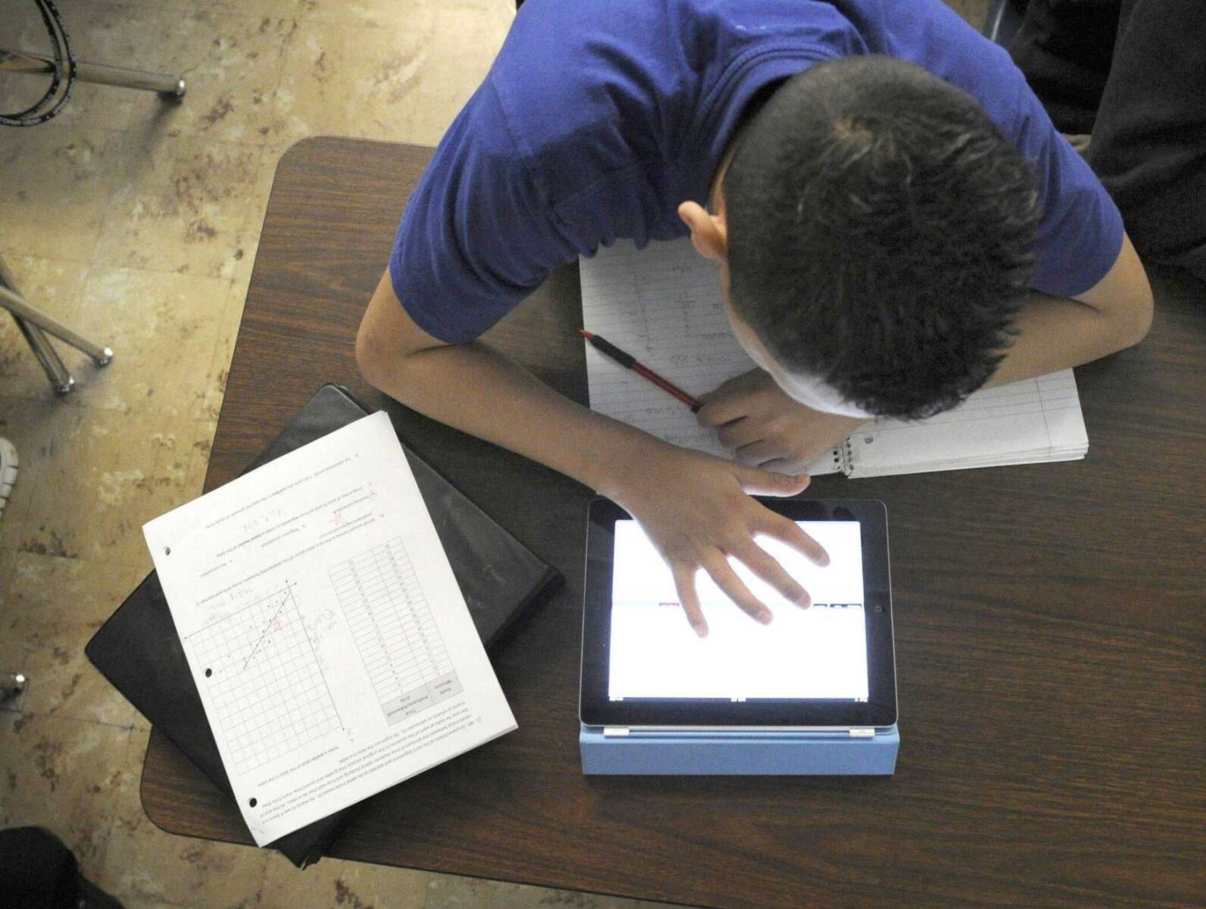 Grant Beacon Middle School student Jeriah Garcia, 13, works out an algebra problem Jan. 17 on his school-supplied iPad in class at Grant, Colo. Apple is expected to reveal a new iPad today.<br>Andy Cross<br>The Denver Post