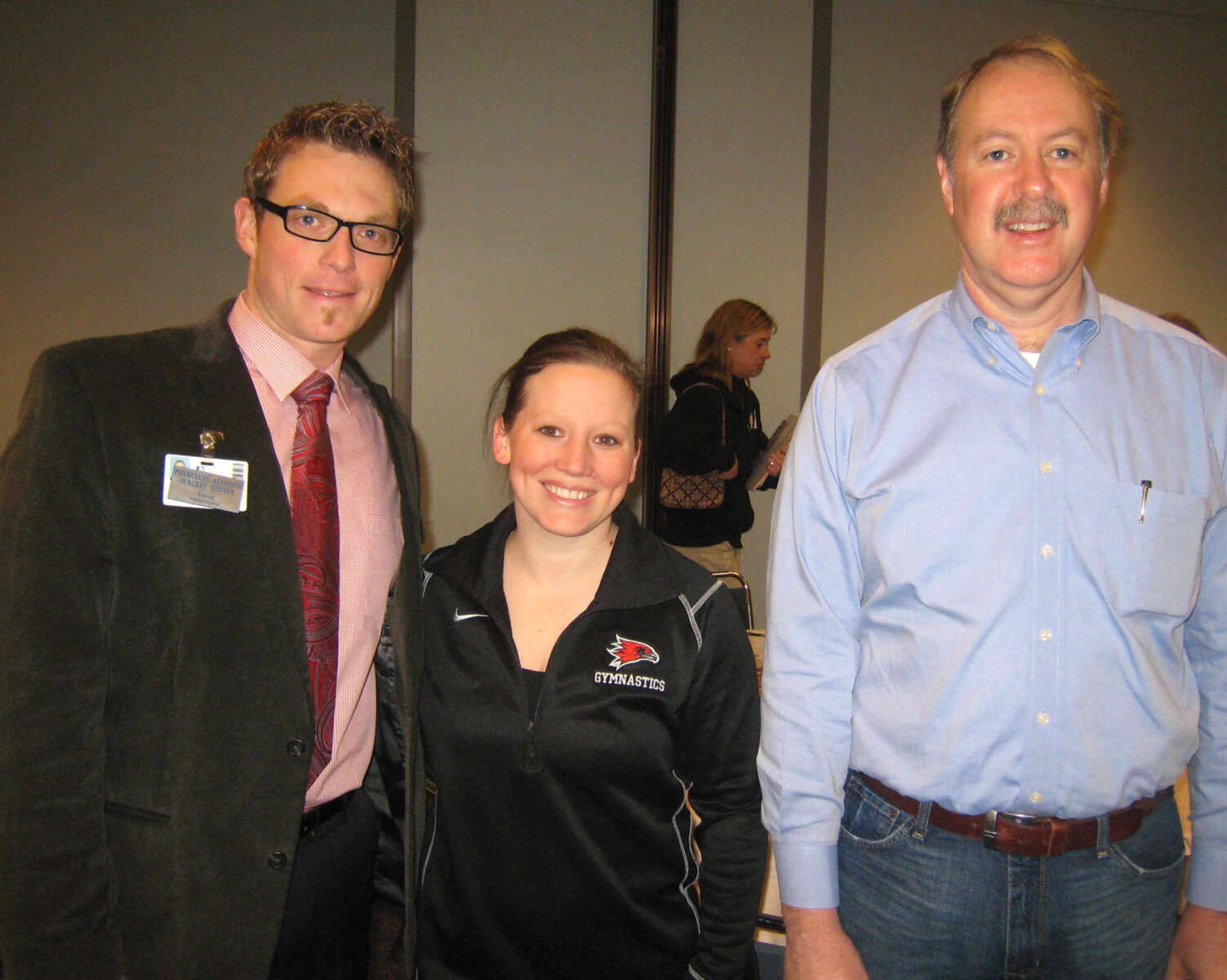 Jason Bandermann, St. Francis Physicians Alliance Surgery Center LLC, left, Kristi Ewasko, Southeast Missouri State University Women's Gymnastics, and Mike Unverferth, CPU, Inc., at the Cape Girardeau Area Chamber of Commerce First Friday Coffee, Feb. 1, at the Show Me Center.