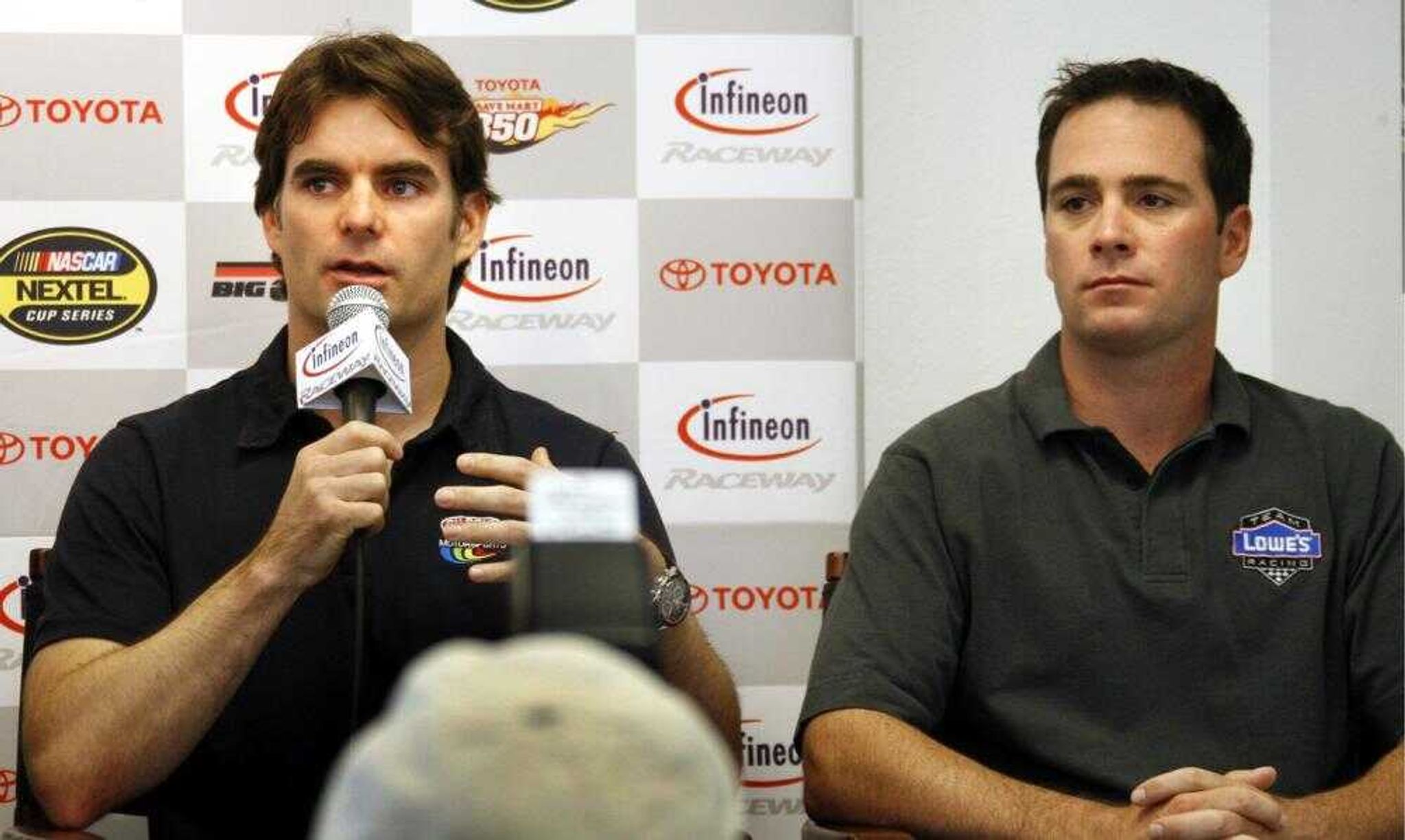 Race driver Jeff Gordon, left, and teammate Jimmie Johnson, of the Hendricks Motorsports team, answer questions from the media after their cars failed inspection before practice for the NASCAR Dodge/Save Mart 350 auto race  Friday, June 22, 2007 in Sonoma, Calif. at Infineon Raceway.  Since they are prohibited from qualifying, both cars would have to start from the rear of the 43-car field in Sunday's race  if they do meet inspection standards. (AP Photo/Dino Vournas)