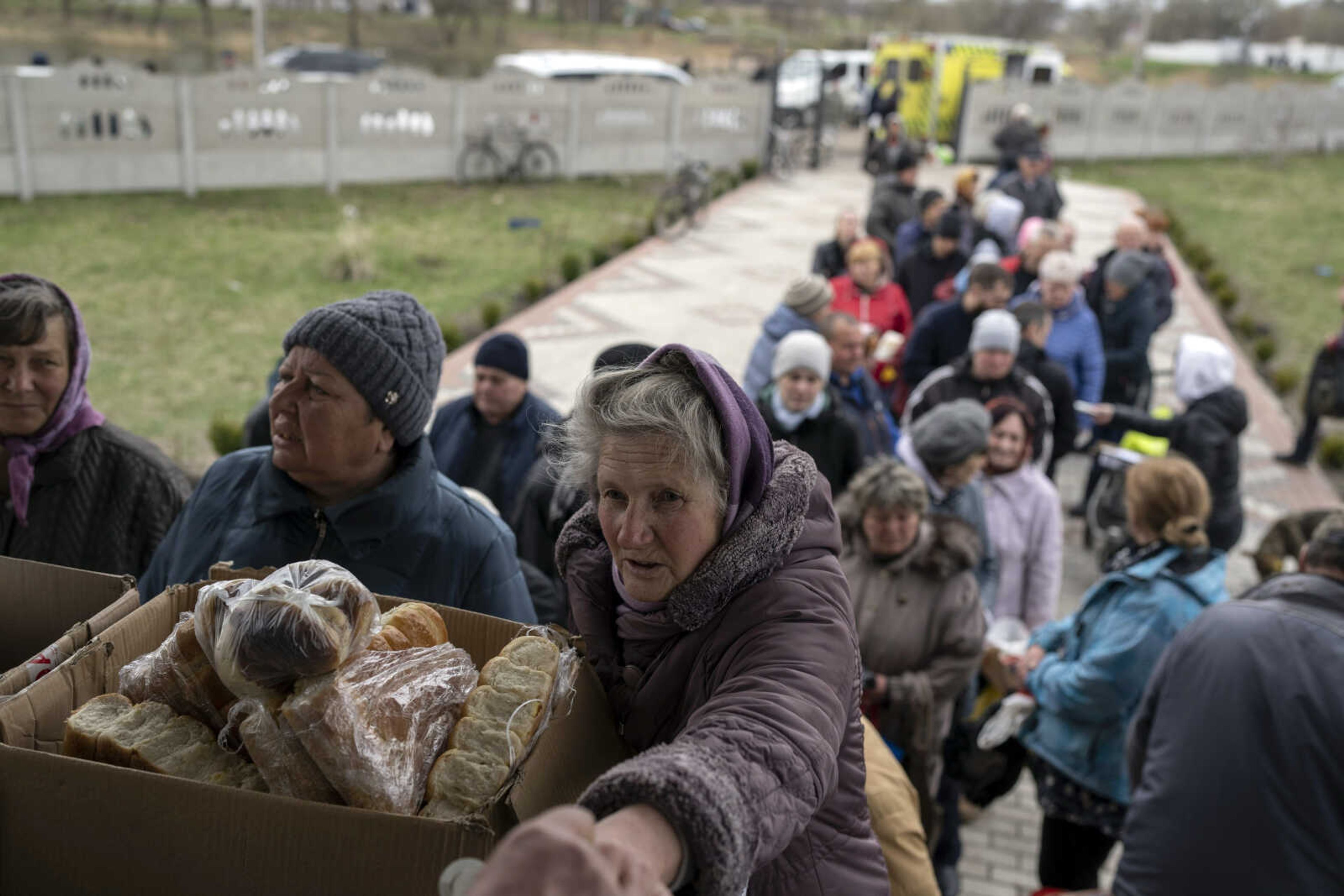 People receive food from a church Sunday in the town of Borodyanka, about 40 miles northwest of Kyiv, Ukraine. Several apartment buildings were destroyed during fighting between the Russian troops and the Ukrainian forces and the town is without electricity, water and heating.