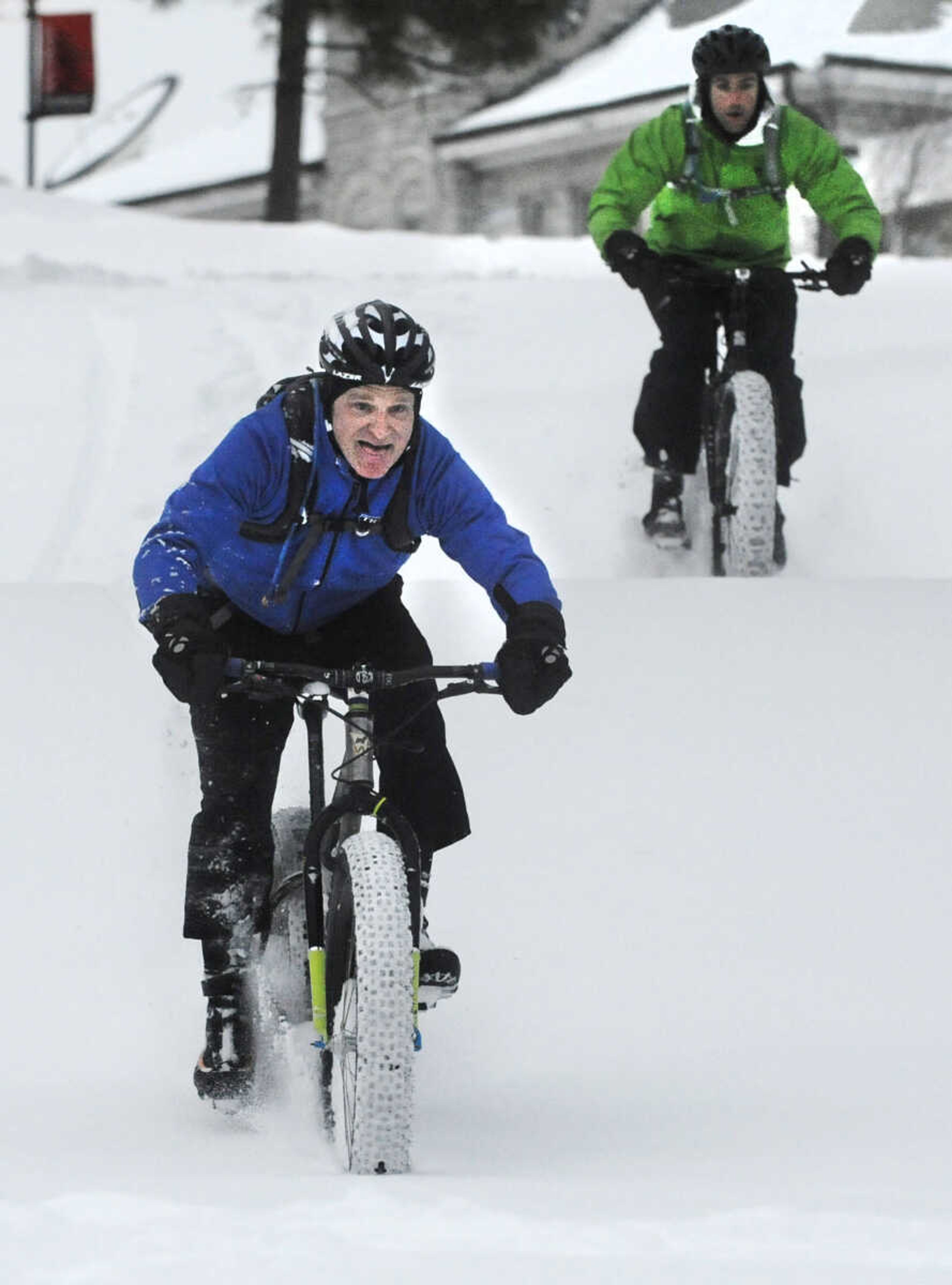 LAURA SIMON ~ lsimon@semissourian.com

John Dodd, front, and Tim Vollink ride fat bikes through the snow on the terraces outside Academic Hall Tuesday evening, Feb. 17, 2015.