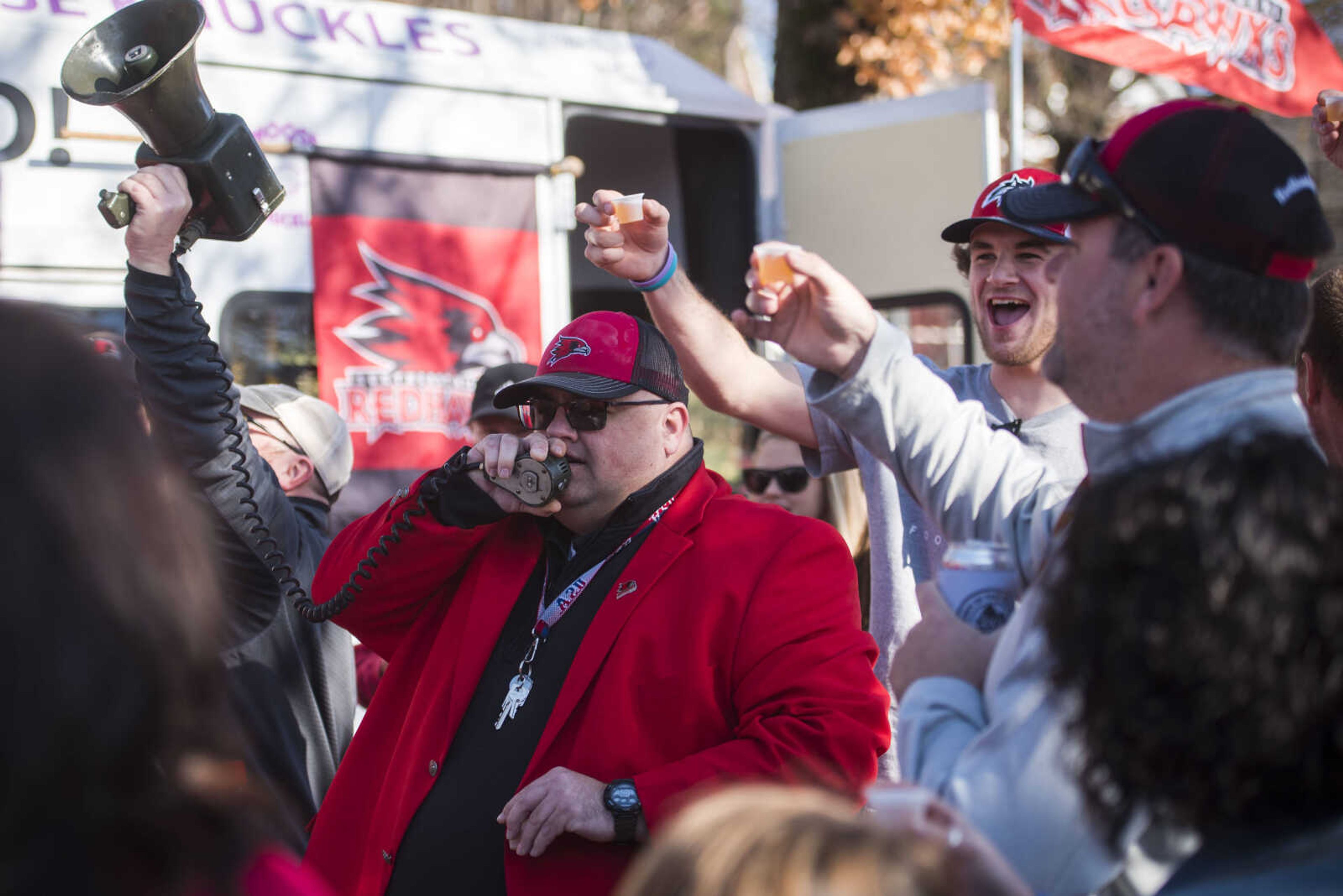 Red Blazer crew member and Southeast Missouri State football tailgate veteran of over 17 years, Jack Trickey, center, speaks on a bullhorn while energizing fans at a Bellevue Street tailgate Saturday, Nov. 24, 2018, in Cape Girardeau.