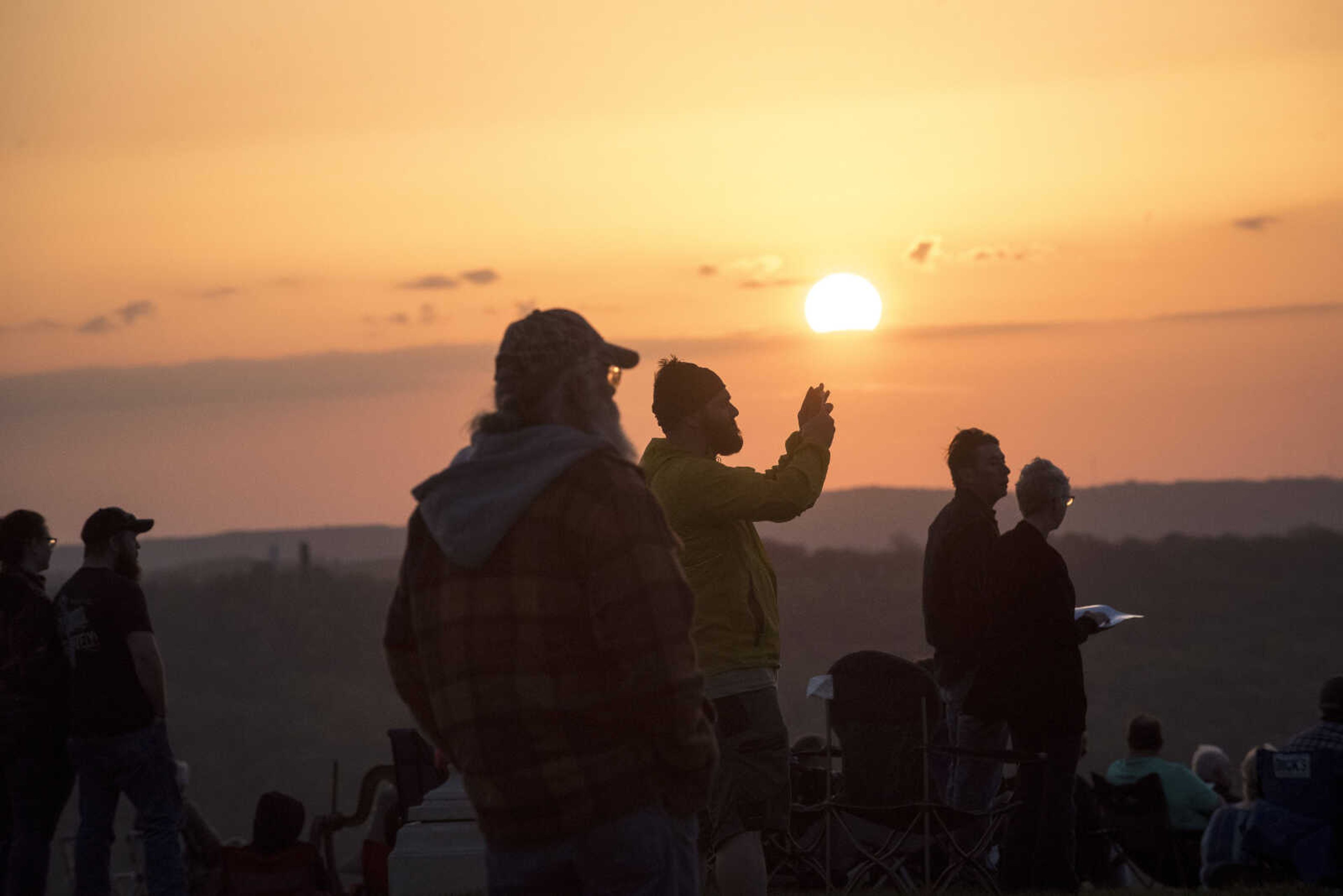 People take pictures as the sun rises during the 81st annual Easter Sunrise Service at the Bald Knob Cross of Peace Sunday, April 16, 2017 in Alto Pass, Illinois.