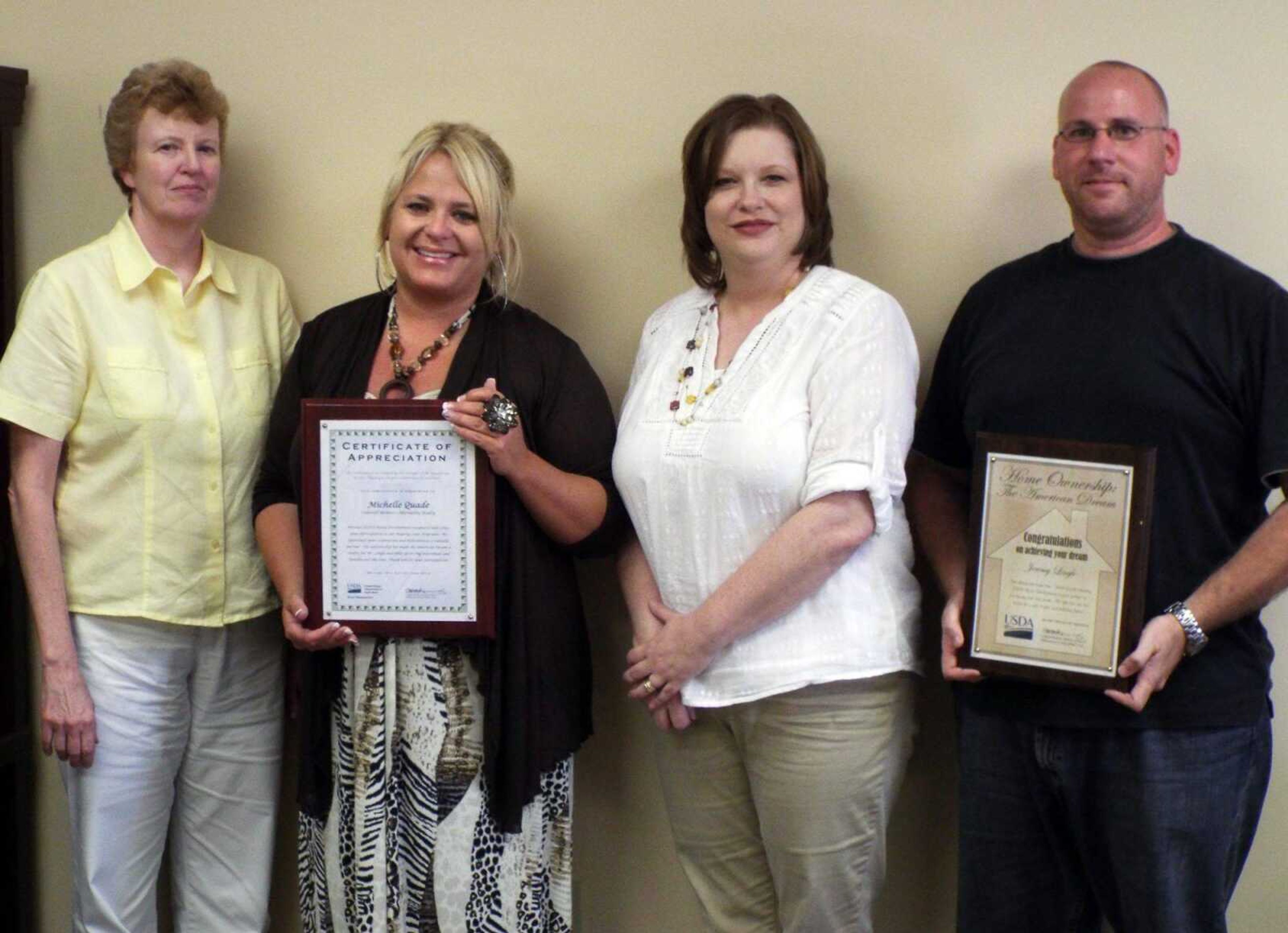 Michelle Quade received recognition from USDA, Rural Development Home Loans. Pictured left are Phyllis Minner, RD area director; Quade; Tracy Jordan, RD area specialist; and Jeremy Lingle, new homeowner. (Submitted)