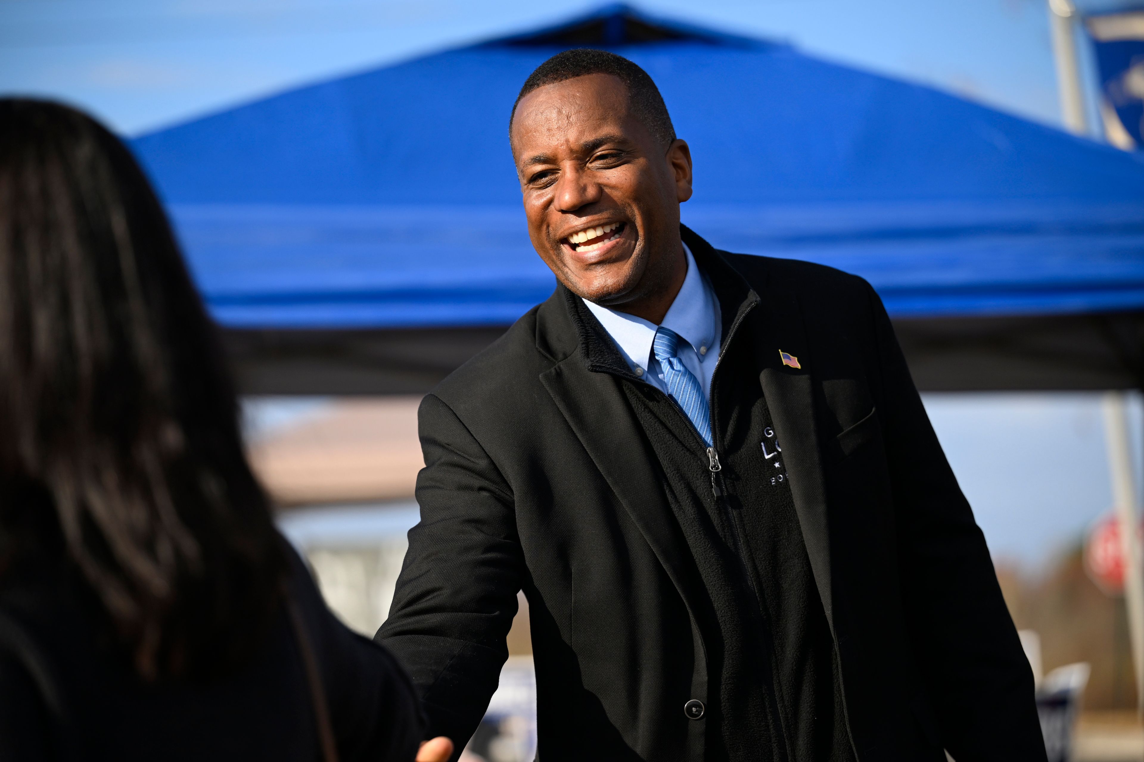 Republican U.S. House candidate George Logan, right, greets voters on Election Day, Tuesday, Nov. 5, 2024, in Brookfield, Conn. (Jessica Hill/Hartford Courant via AP)