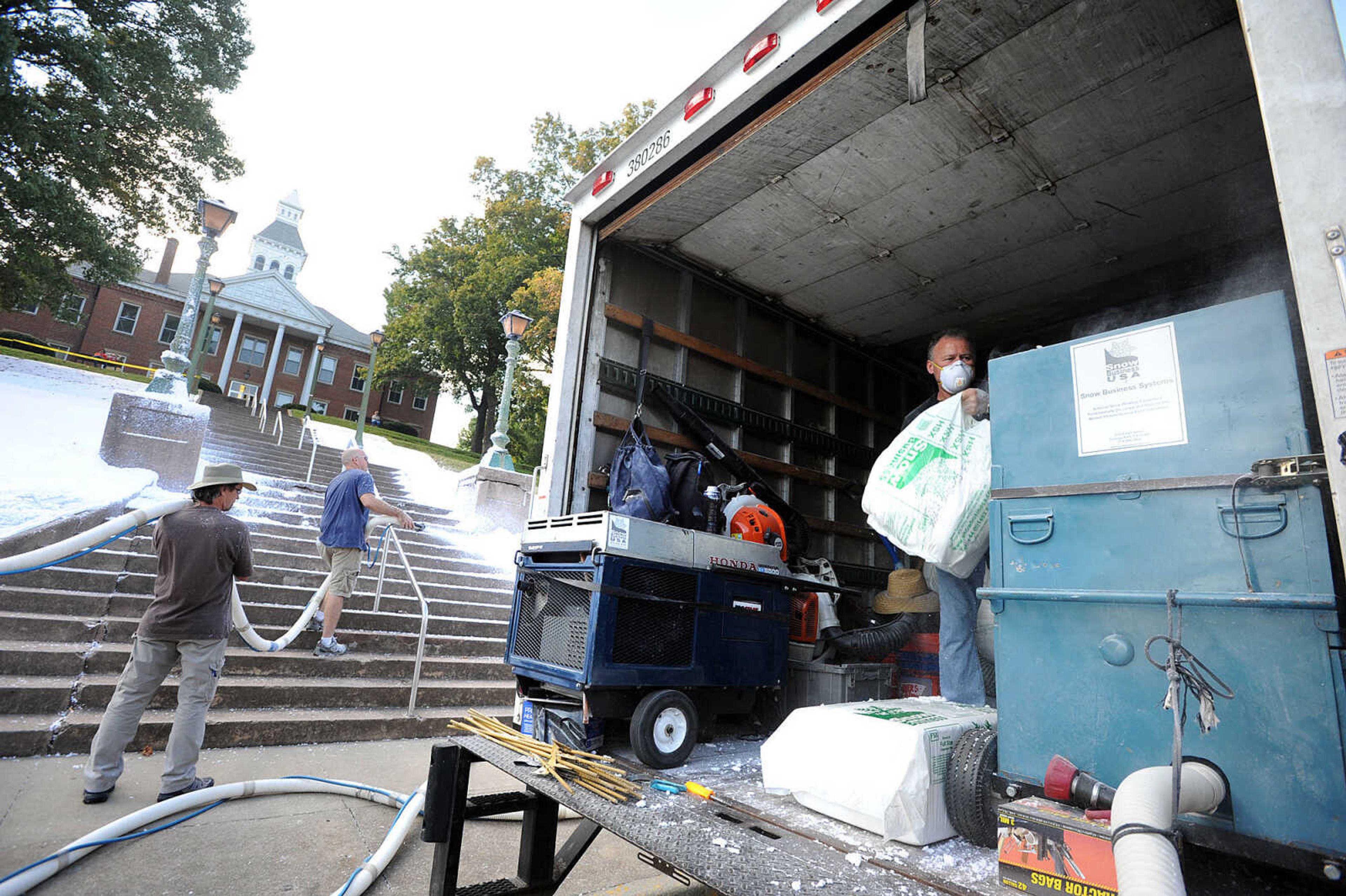 LAURA SIMON ~ lsimon@semissourian.com

Snow-crew members spray "snow" on the lawn and steps of the Common Pleas Courthouse on Friday, Oct. 11, 2013, in Cape Girardeau. The "snow" is made of paper with a slight moisture content, and will be used for a scene from the feature film "Gone Girl."