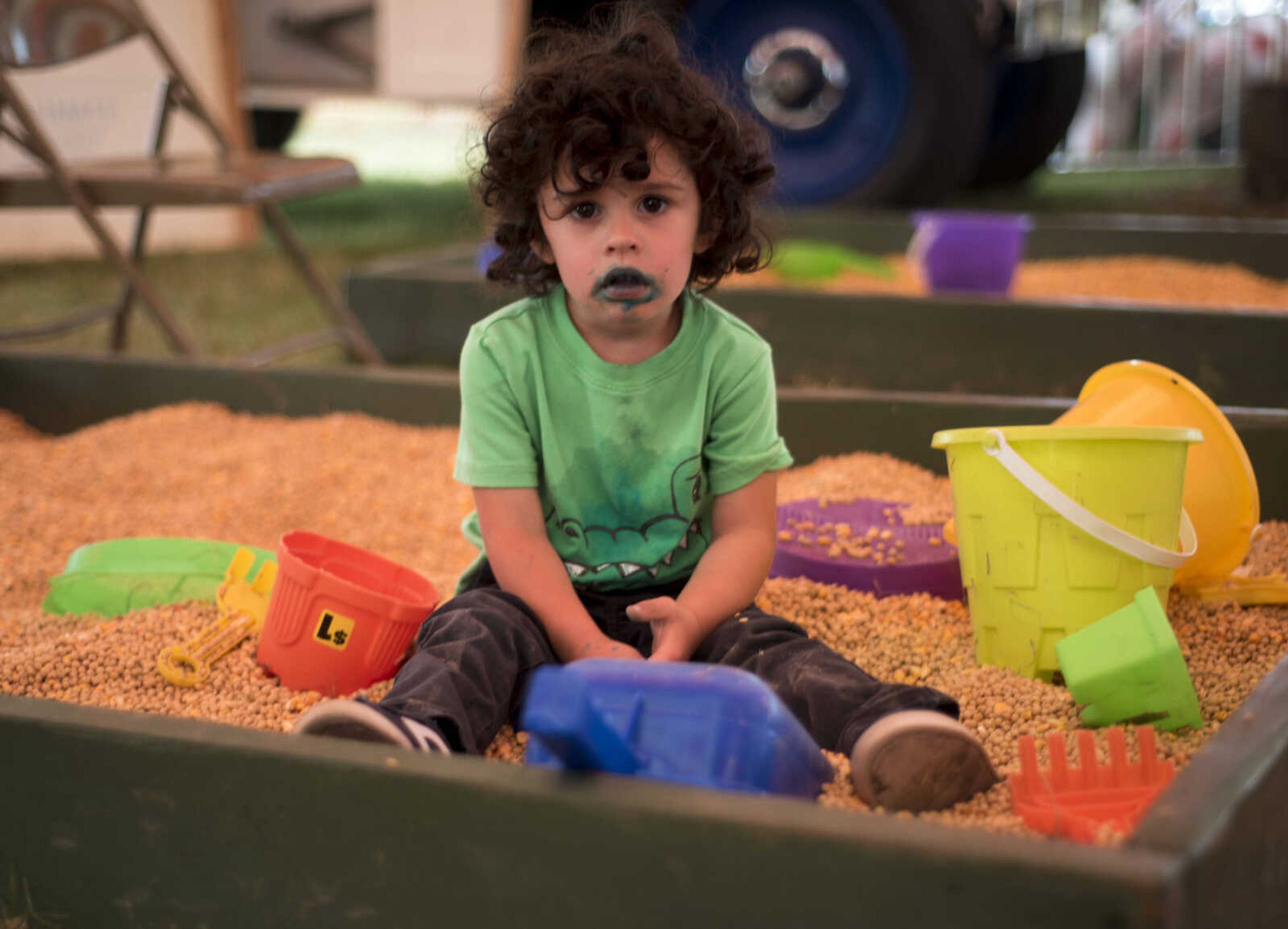 Danny Gamadia, 2, plays in soybeans at the SEMO District Fair on September 11, 2017, in Cape Girardeau.