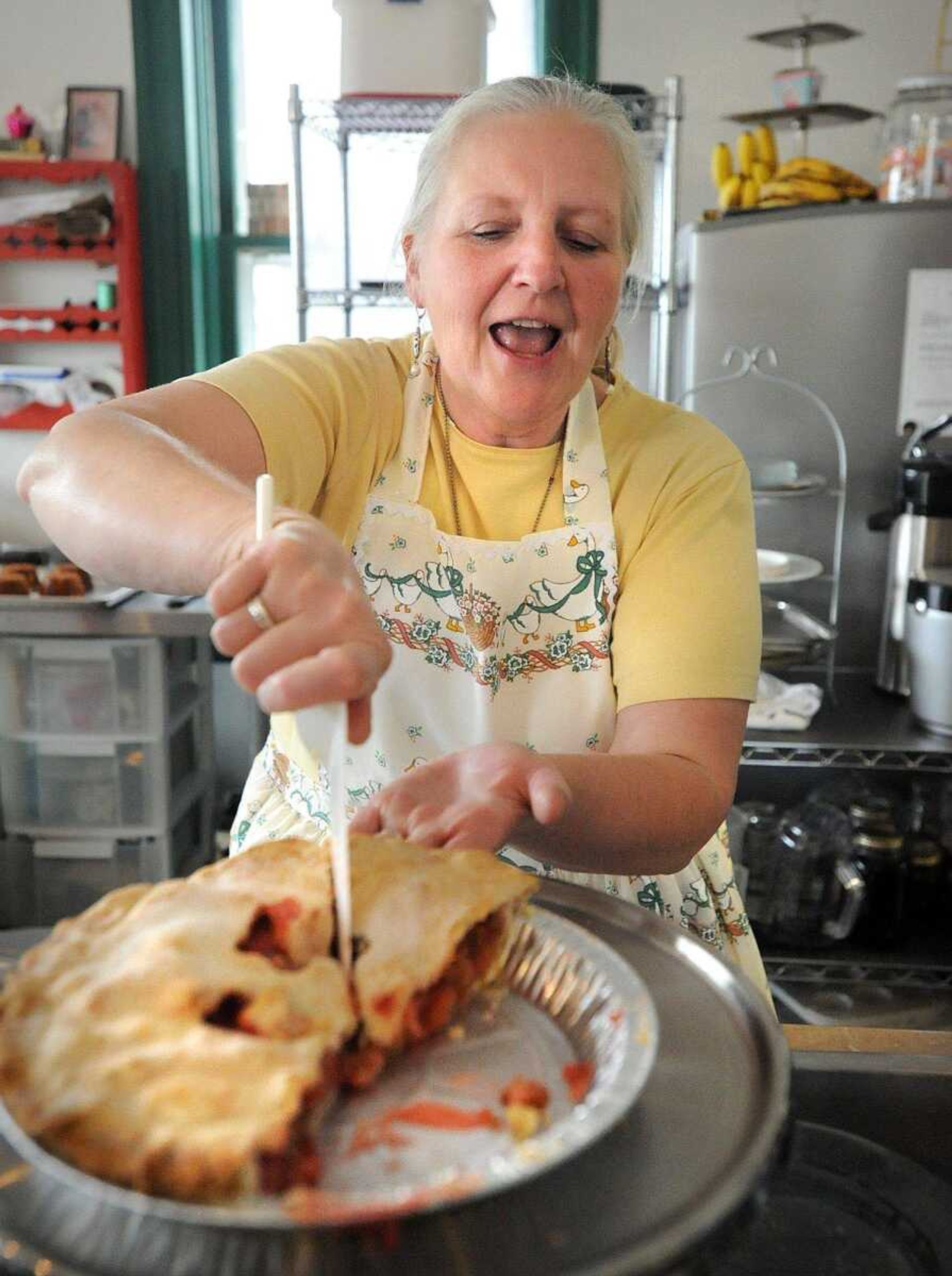 Sharon Penrod slices a piece of strawberry-rhubarb pie for a customer Sunday at her Pocahontas bakery and cafe, the Pie Safe. The Pie Safe was one of many stops along the 23rd annual Mississippi River Valley Scenic Drive. (Laura Simon)