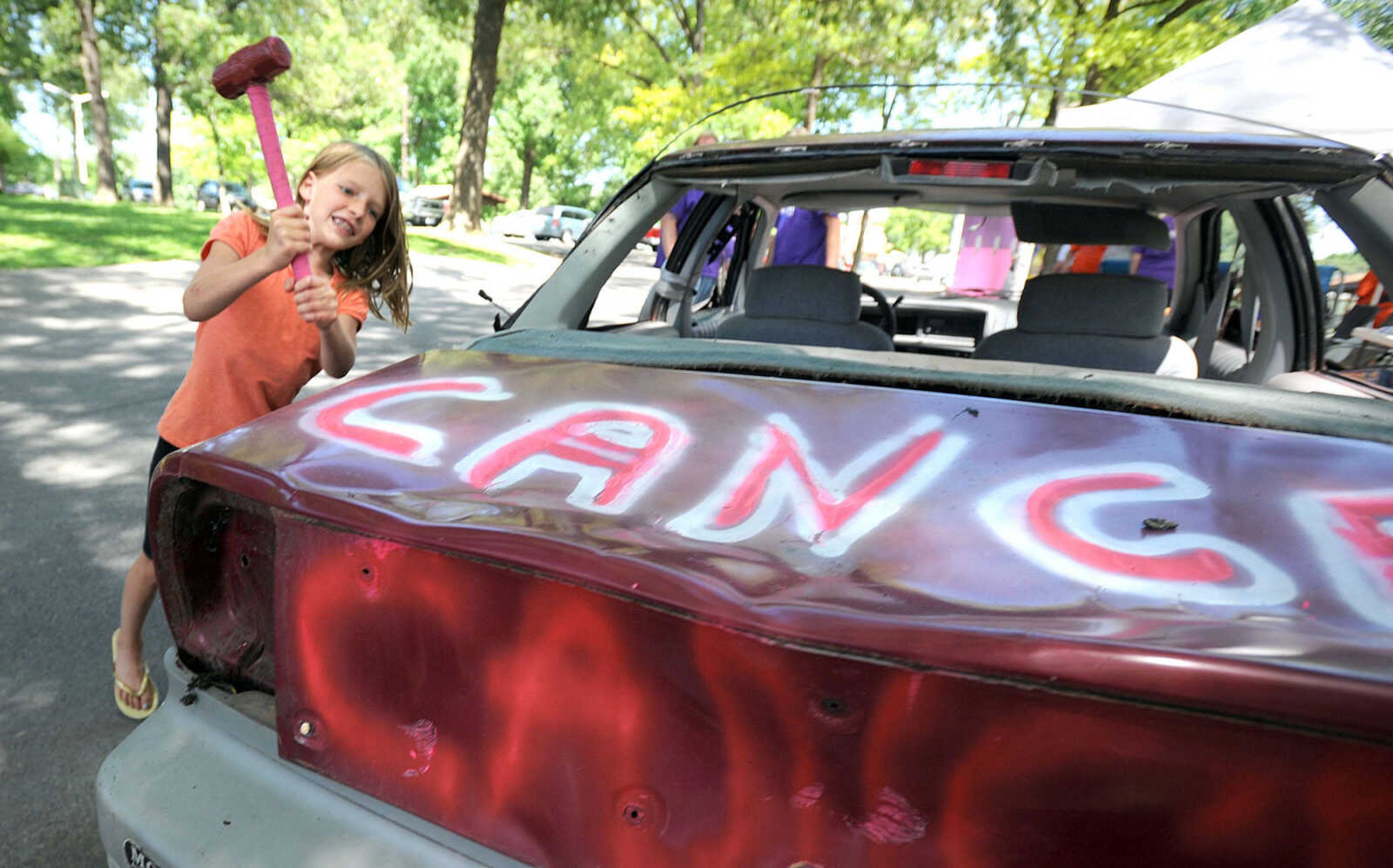 LAURA SIMON ~ lsimon@semissourian.com

Ellie Brown takes a whack at the trunk of a car, Saturday, June 14, 2014, during the Relay for Life of Cape Girardeau County fundraiser at Arena Park. People got three chances for a dollar to "help beat cancer"  at the "Got Hope" tent.