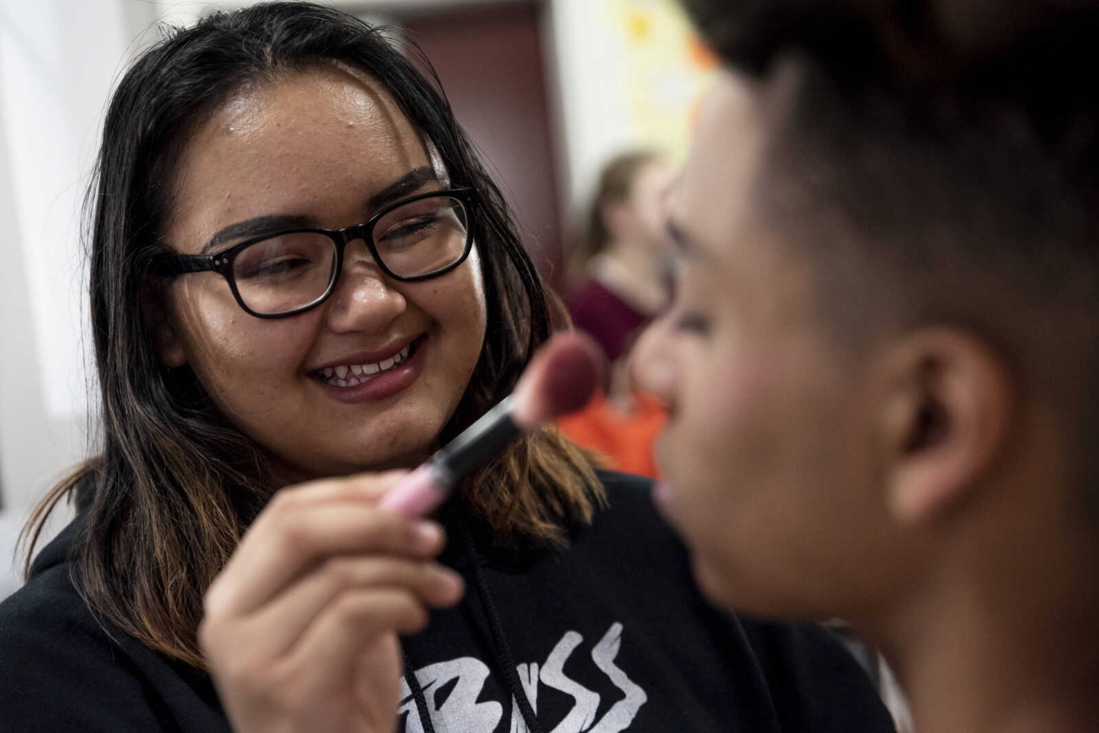 Po Nwe, 16, does makeup for Izahia Betancur, 16, as he prepares for his role of Sky during the media night of Cape Central High School's spring musical production of "Mamma Mia!" Wednesday, April 10, 2019, in Cape Girardeau.