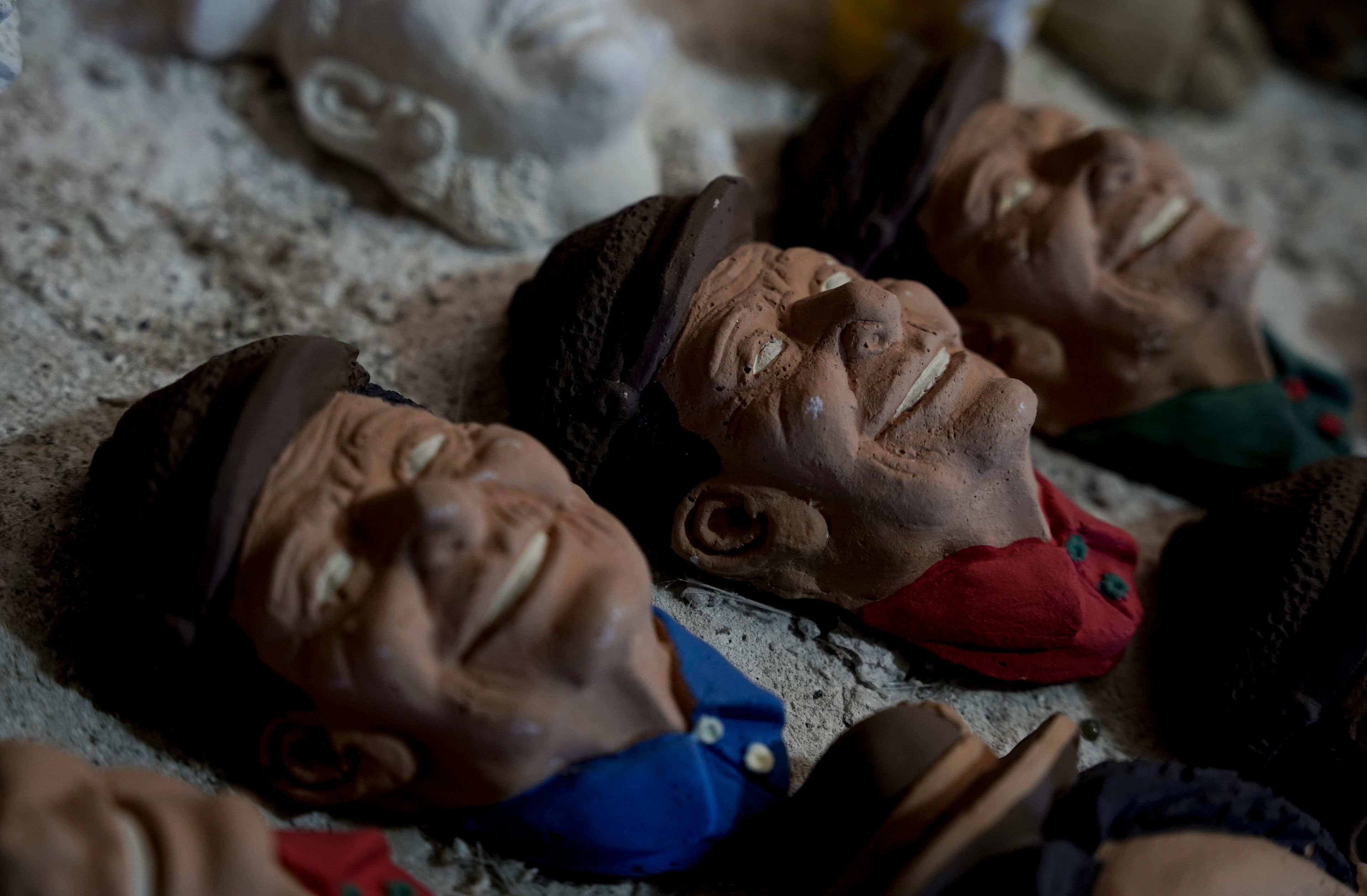 Masks created by artisan William Luna to adorn a sweet bread called tantawawa, traditional for Day of the Dead celebrations, are set on a table at his workspace, in La Paz, Bolivia, Thursday, Oct. 31, 2024. (AP Photo/Freddy Barragan)