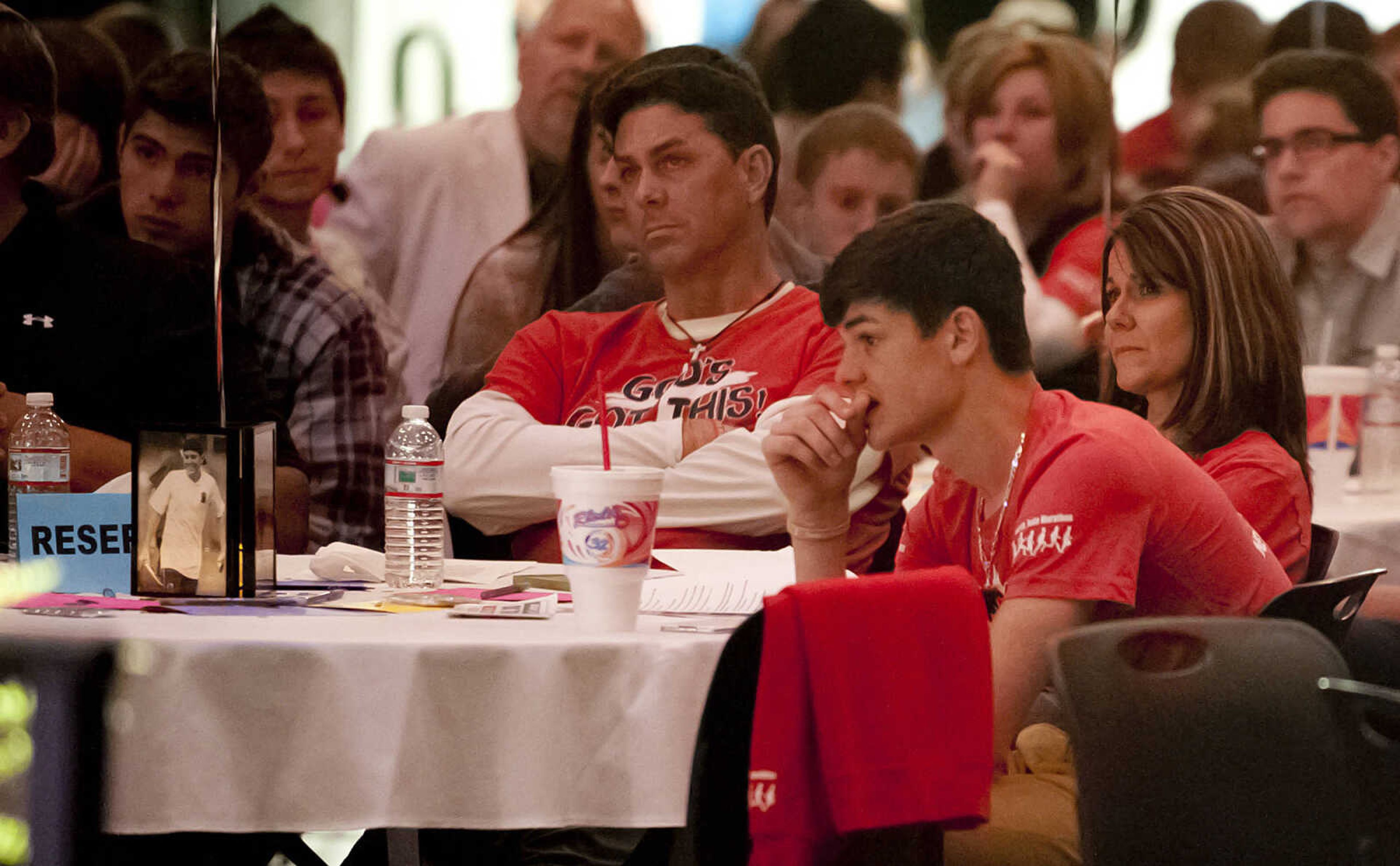 Dean, left, Rachelle and Colton Weber listen as Lucas Clabough, senior pastor of First Baptist Church in Jackson, speaks about Nolan Weber during "Nolan Weber, Celebration of Life," Wednesday, April 30, at the Jackson High School Event Center. Friends, family and community members gathered to remember the former Jackson High School baseball and soccer player who passed away from brain cancer in December on what would have been Nolan's 19th birthday.