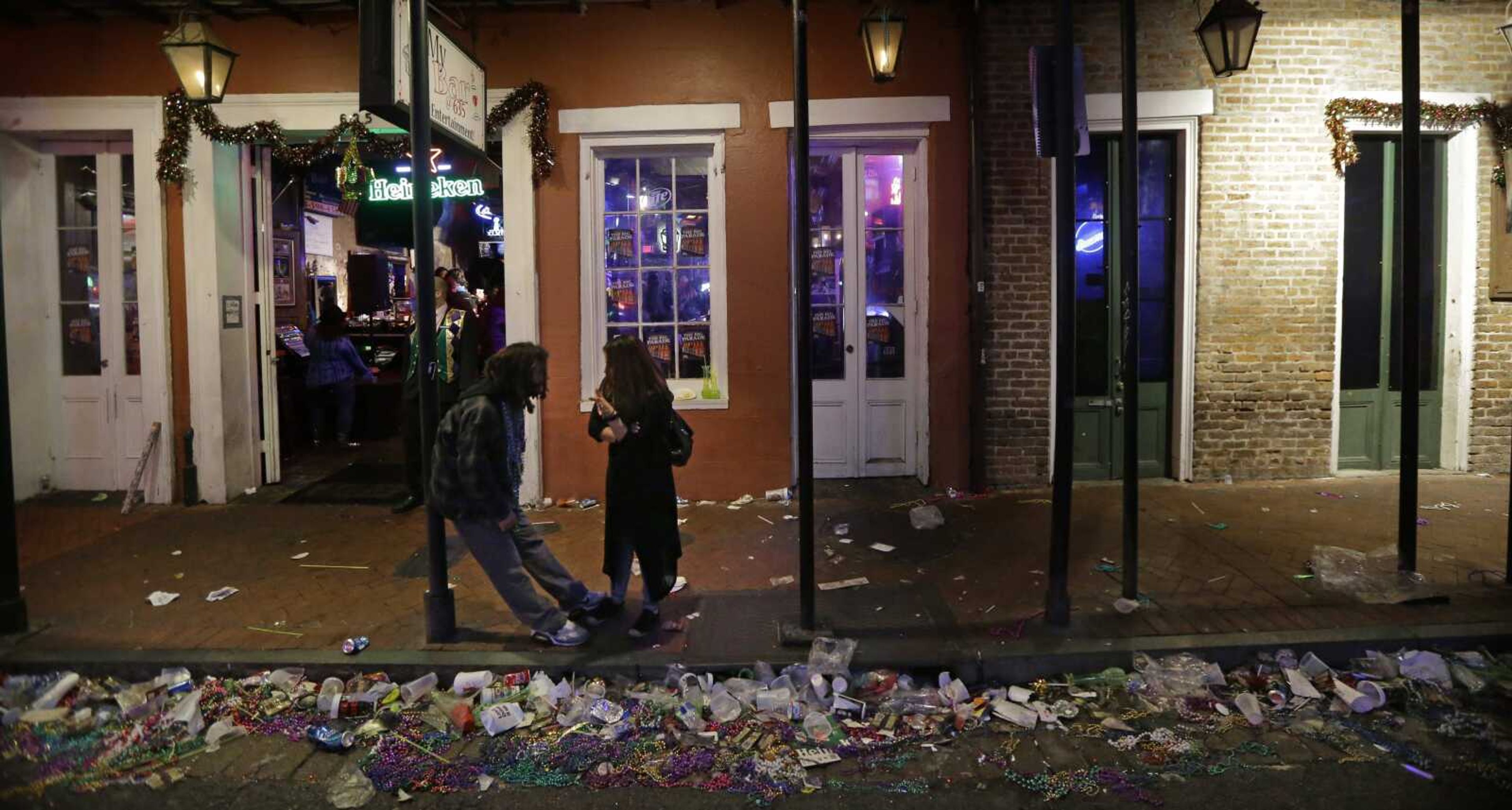 Trash lines the gutter on Bourbon Street in the early hours of the morning Wednesday after Mardi Gras in the French Quarter of New Orleans. (Gerald Herbert ~ Associated Press)