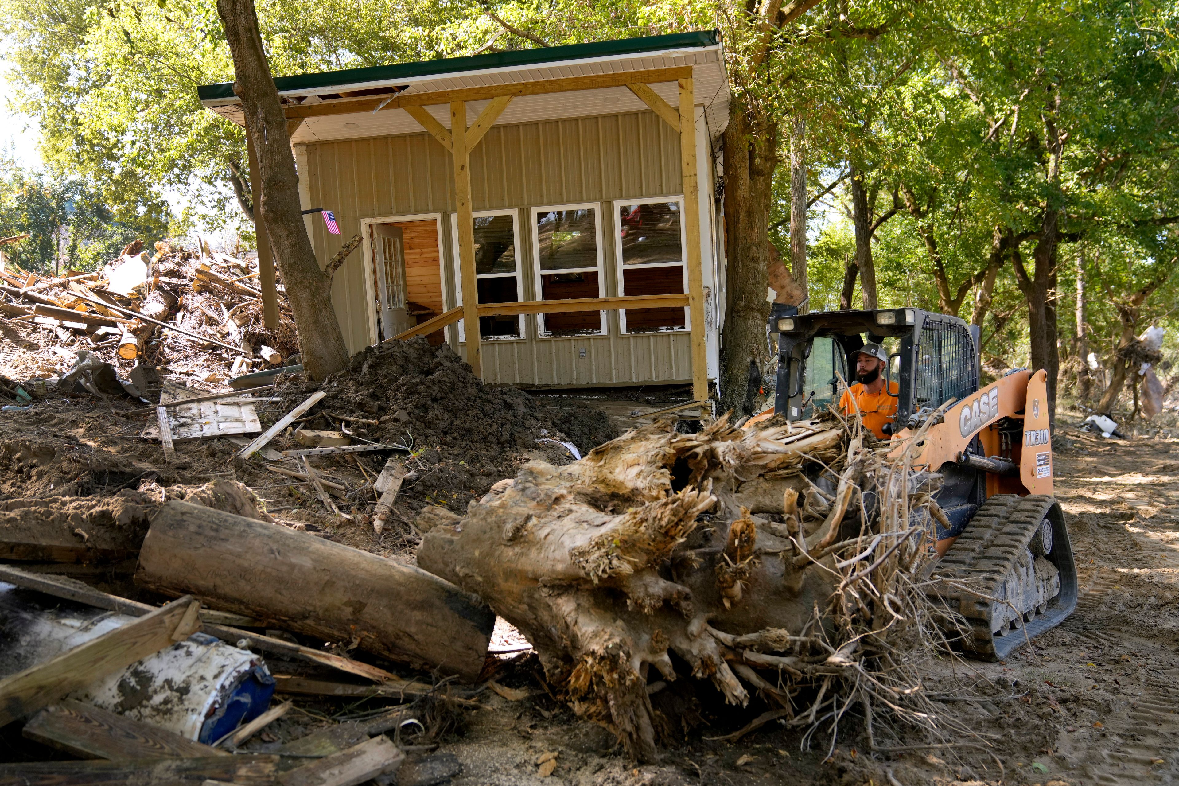 Debris left in the aftermath of Hurricane Helene is cleared Saturday, Oct. 5, 2024, in Del Rio, Tenn. (AP Photo/Jeff Roberson)