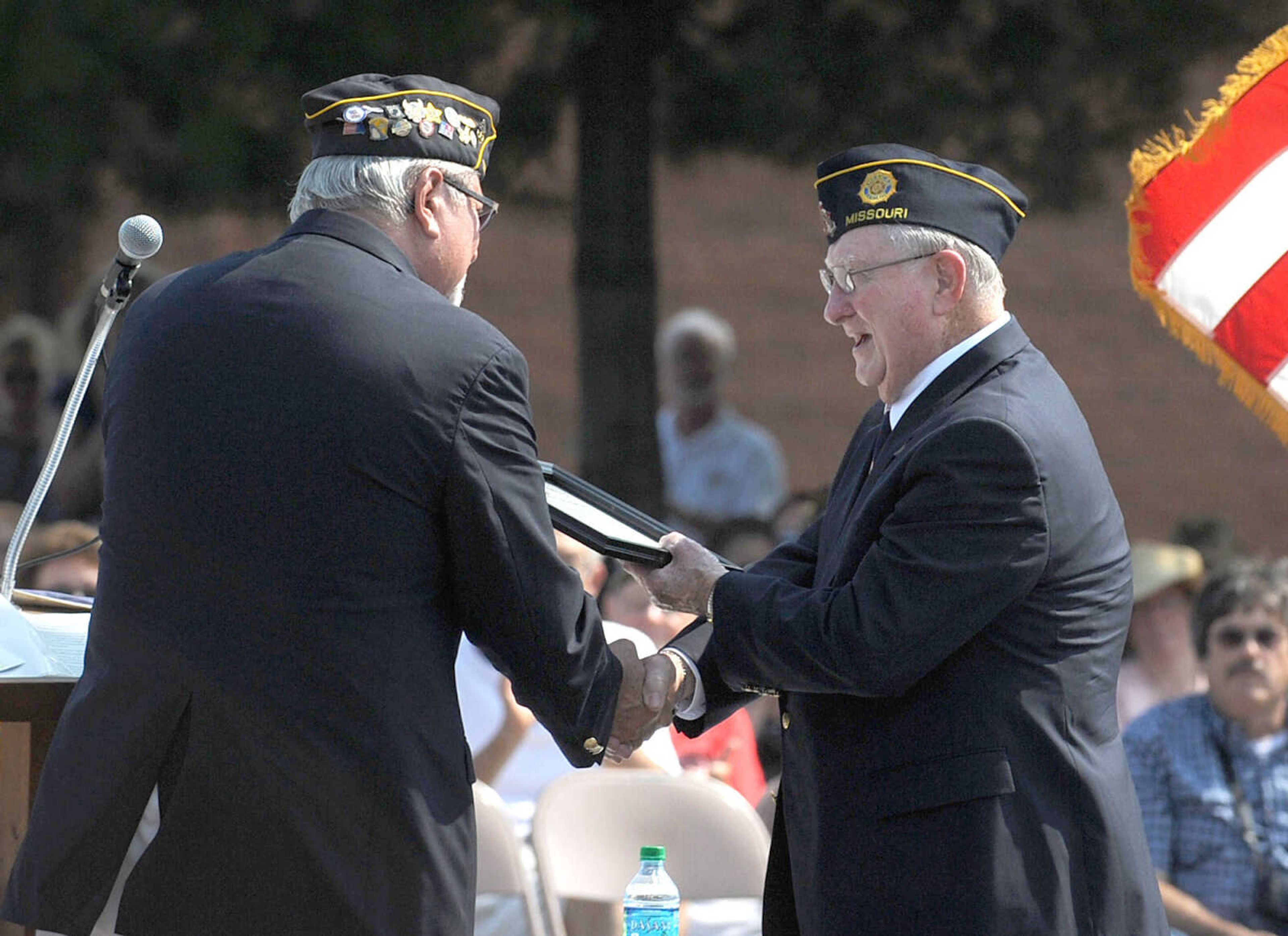 LAURA SIMON ~ lsimon@semissourian.com
David Ludwig, left, honors guest speaker Kenneth Bender Monday morning, May 28, 2012 at the Memorial Day service at Jackson City Cemetery.