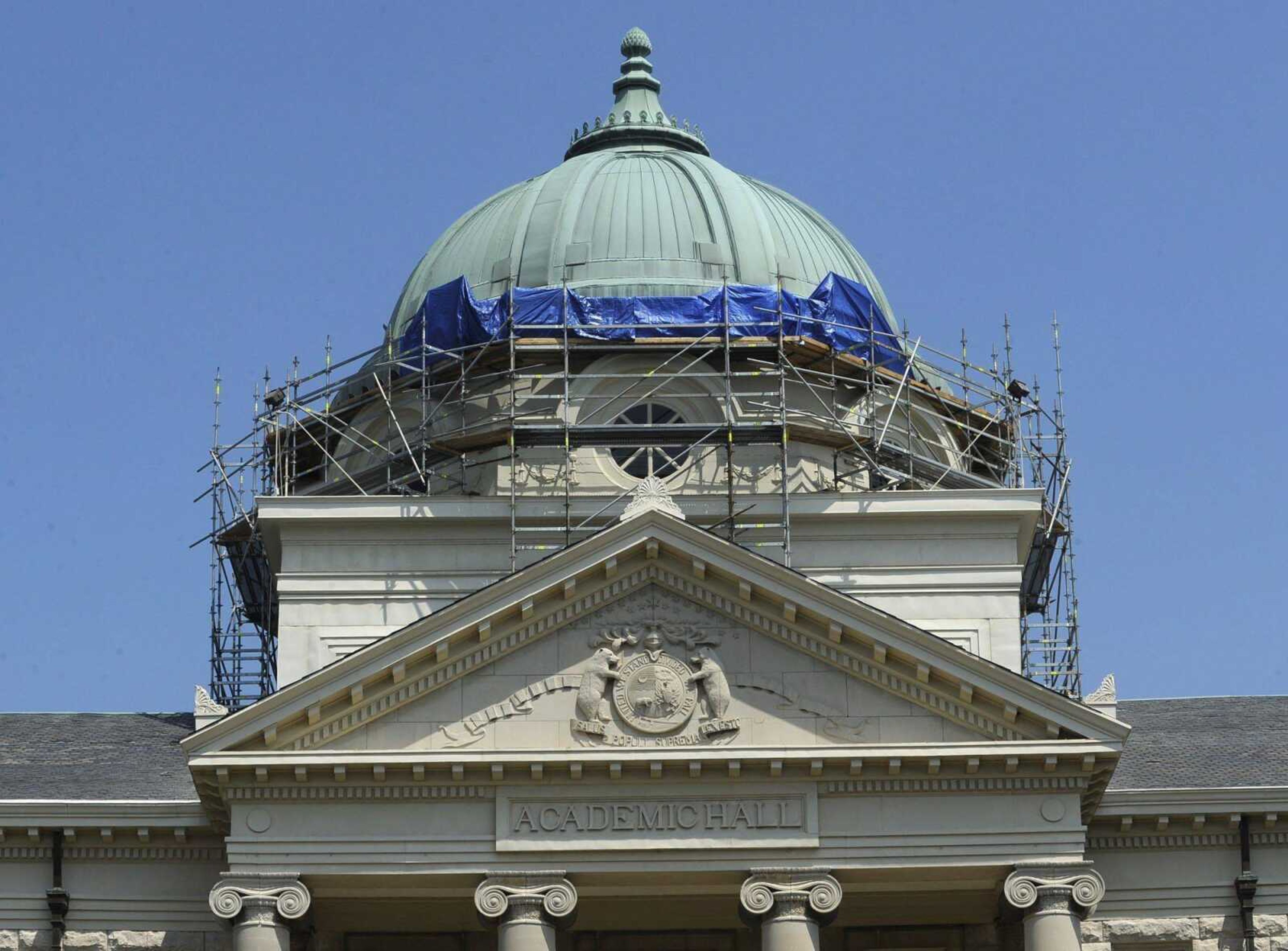 Tarpaulins cover graffiti Wednesday that was spray-painted by vandals on the dome of Academic Hall. The scaffolding has been in place for renovation of the dome. (Fred Lynch)