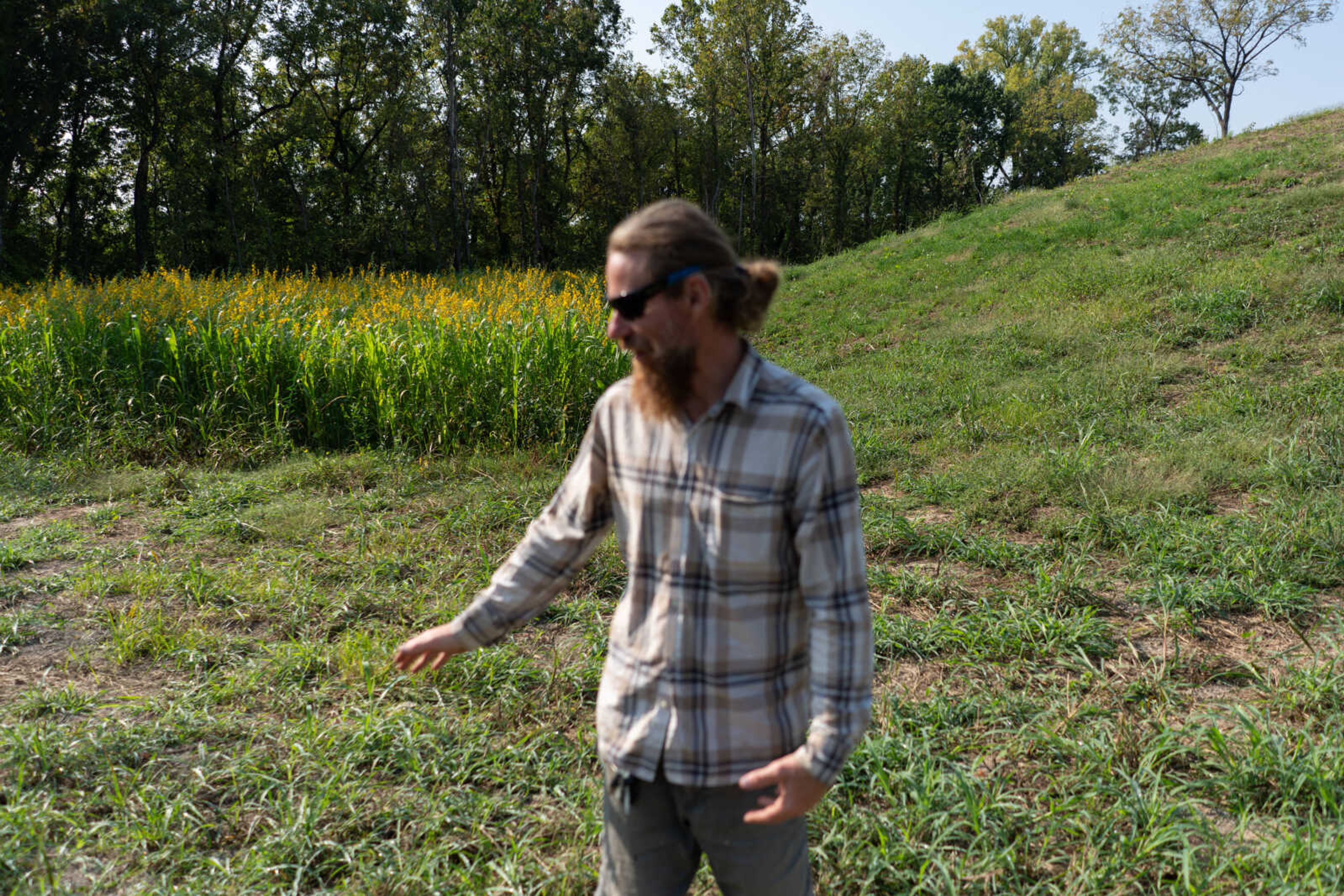 With cover crops growing at the base of a hill at South Side Farms, farm manager Jake Smith discusses possible plans for the future of the land.