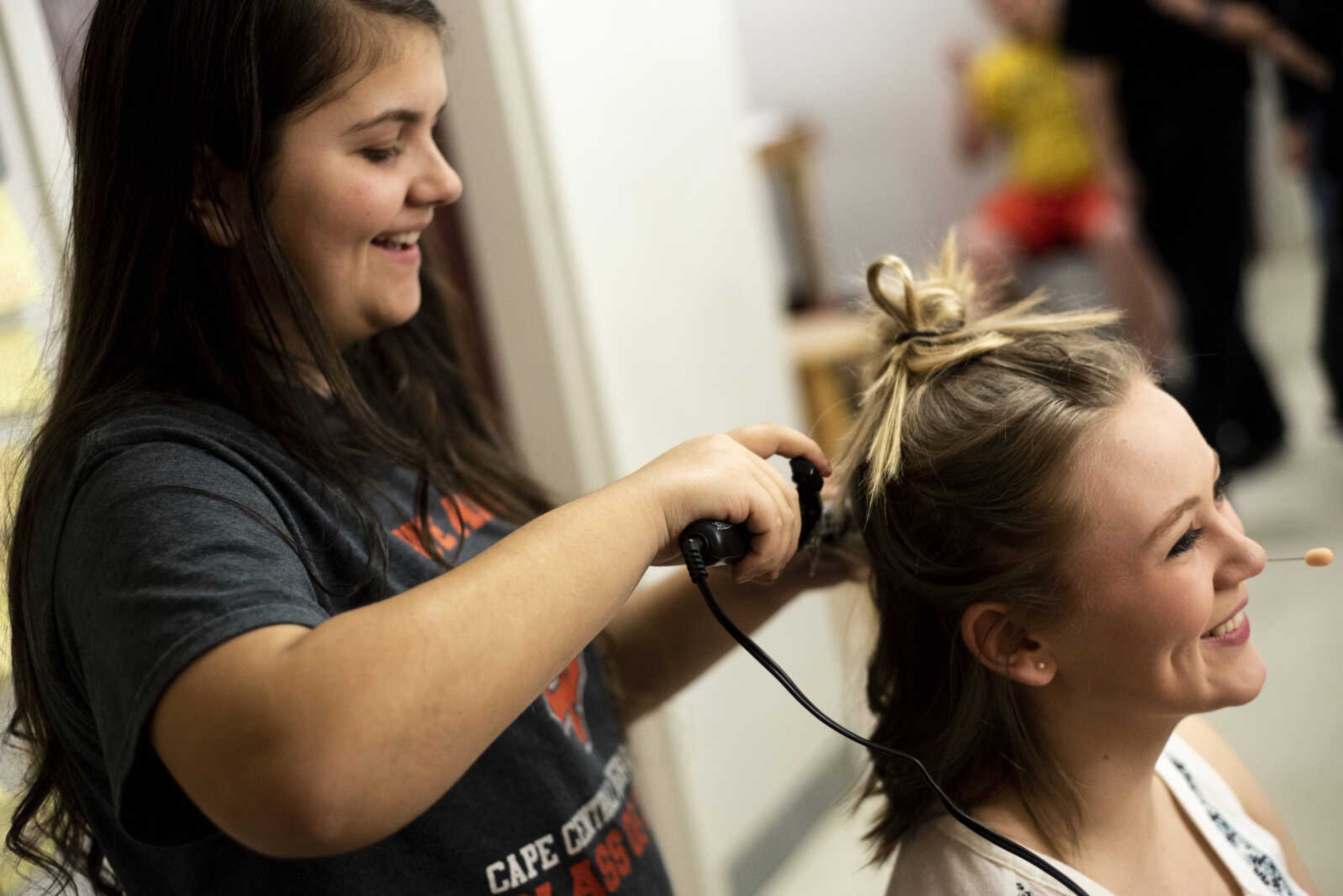 Jordan B‡bers, 14, curls Hannah Hansen's, 17, hair as she prepares for her role of Sophie Sheridan during the media night of Cape Central High School's spring musical production of "Mamma Mia!" Wednesday, April 10, 2019, in Cape Girardeau.