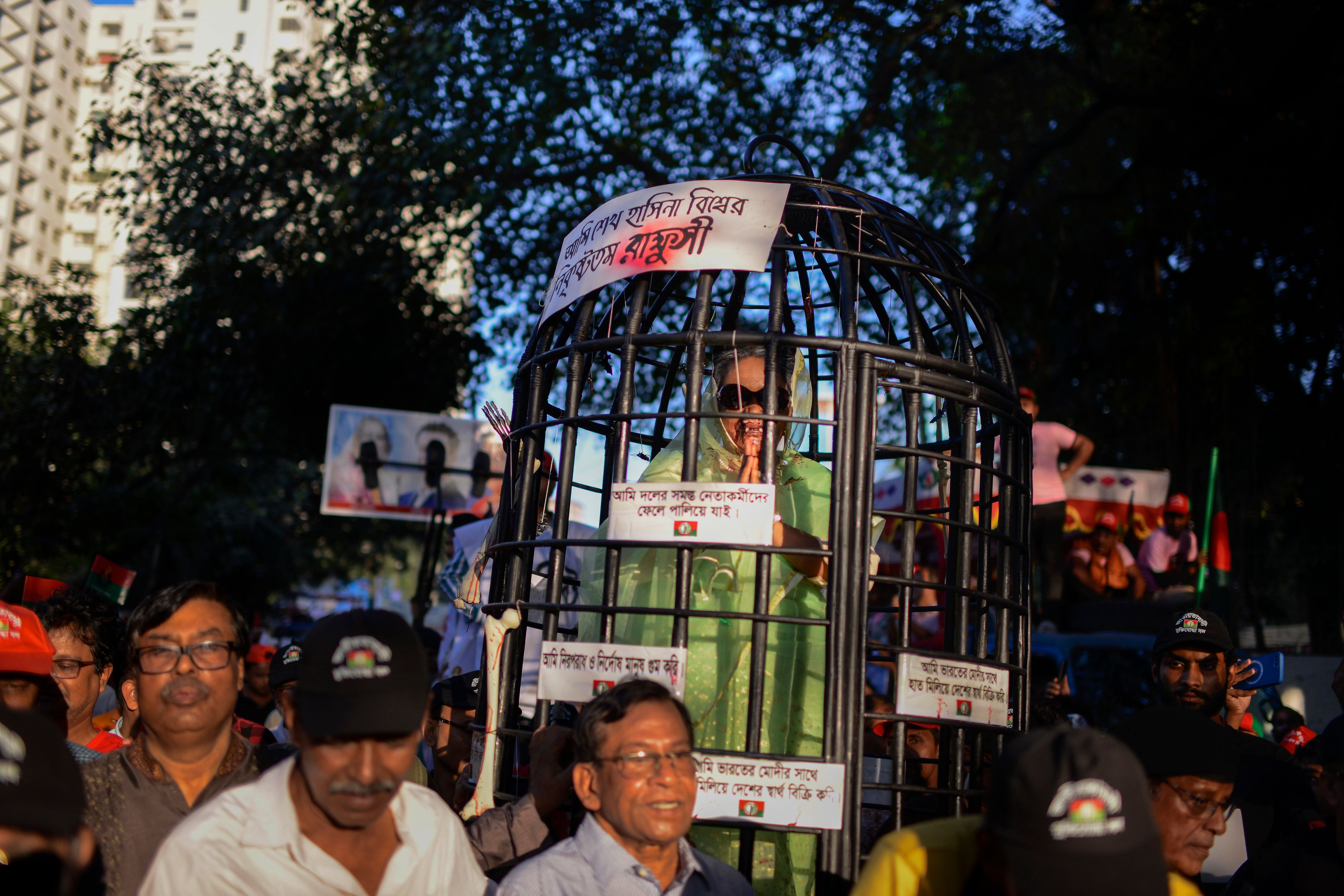 Bangladesh Nationalist Party (BNP) activists participate in a rally as they carry a cage with a person dressed as Sheikh Hasina in Dhaka, Bangladesh, Friday, Nov. 8, 2024. (AP Photo/Mahmud Hossain Opu)