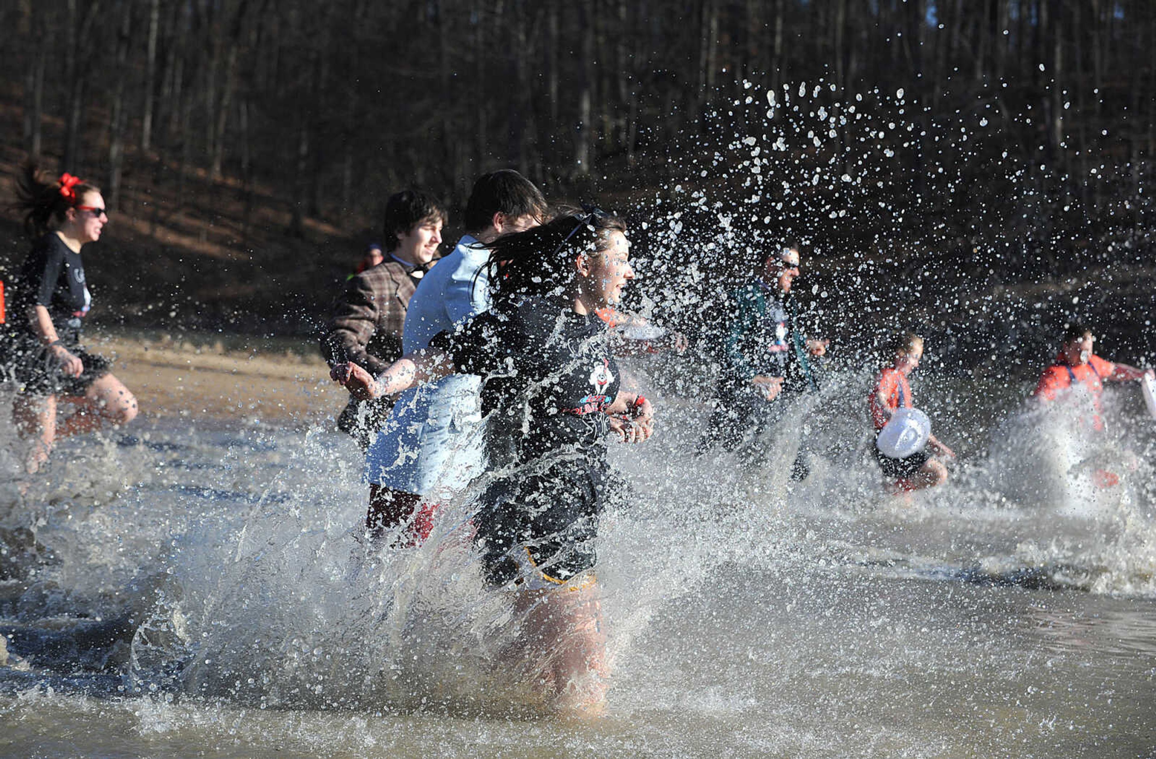 LAURA SIMON ~ lsimon@semissourian.com
People plunge into the cold waters of Lake Boutin Saturday afternoon, Feb. 2, 2013 during the Polar Plunge at Trail of Tears State Park. Thirty-six teams totaling 291 people took the annual plunge that benefits Special Olympics Missouri.