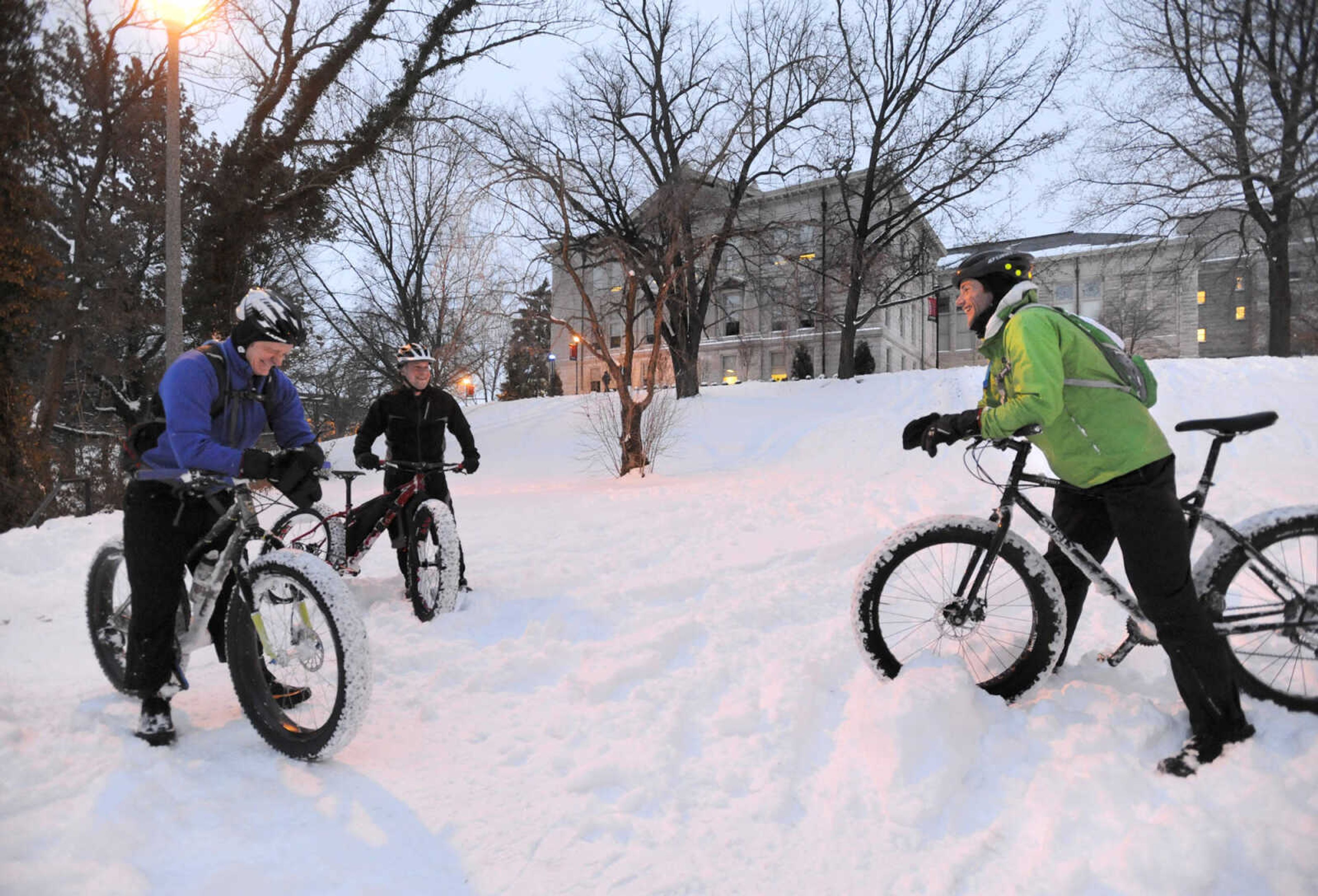 LAURA SIMON ~ lsimon@semissourian.com

John Dodd, left, Bob Berck, center, and Tim Vollink take a break from riding fat bikes through the snow on the terraces outside Academic Hall Tuesday evening, Feb. 17, 2015.